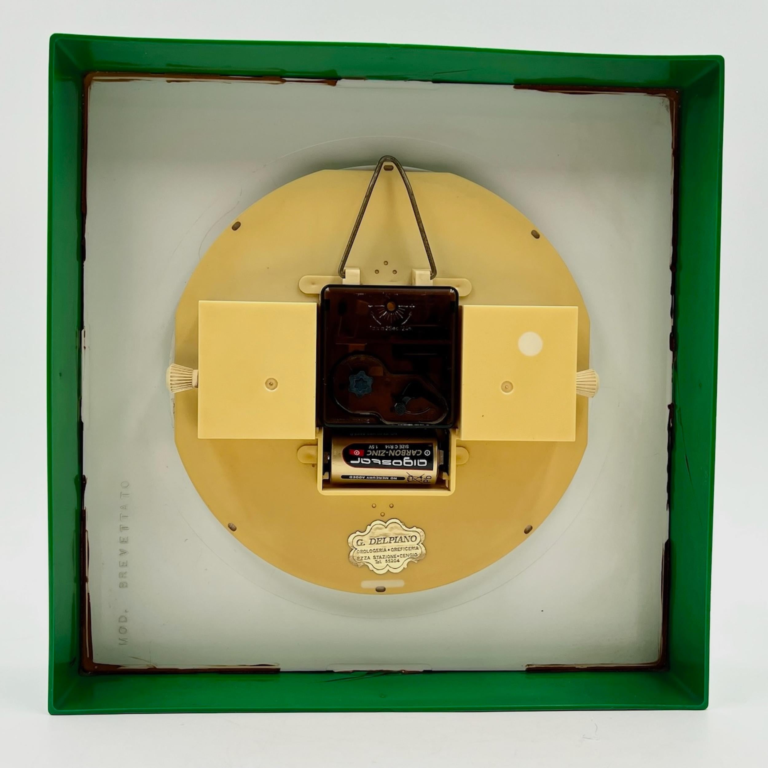 This vintage 1960s/70s wall clock combines timeless design with functional precision. Featuring a green plastic frame and a gold dial with bold 70s-style typography, it stands out as both a decorative and practical object. The clock includes an