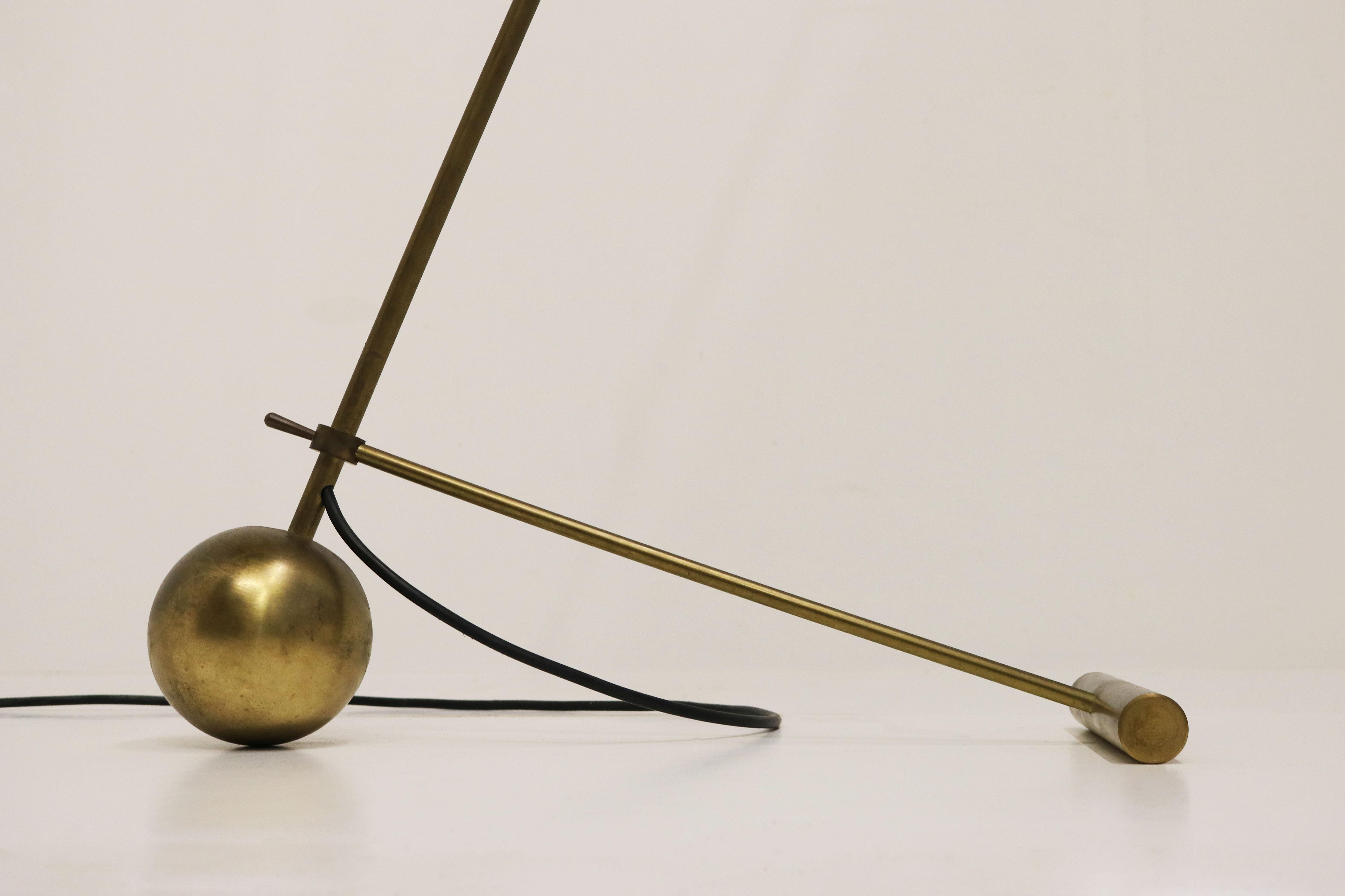 Gorgeous minimalist Italian design floor lamp in style of Stilnovo 1950. 
Frame made out of patinated brass with unique minimalist design base. Gorgeous diabolo shaped shade in yellow. Timeless design ! 
The angle of the floor lamp & the shade can