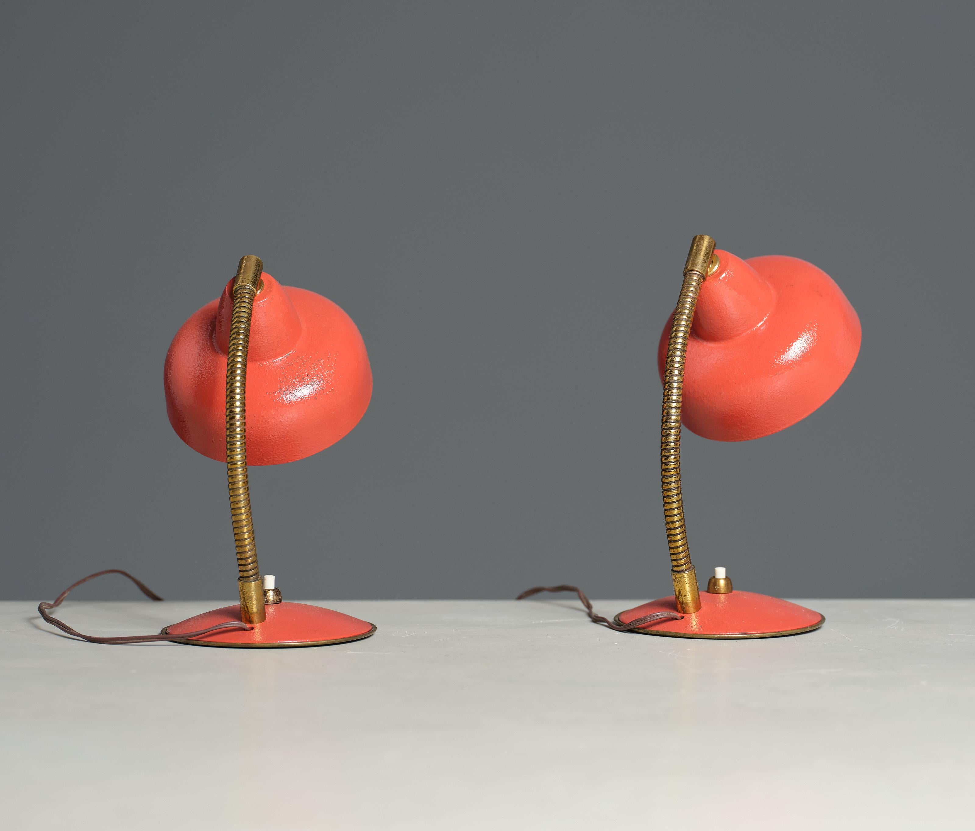 Add a pop of colour and vintage charm to your home with this exquisite pair of Italian design table lamps. Crafted in Italy during the 1950s, these lamps feature a stunning coral colour and a unique directional light design that adds a touch of