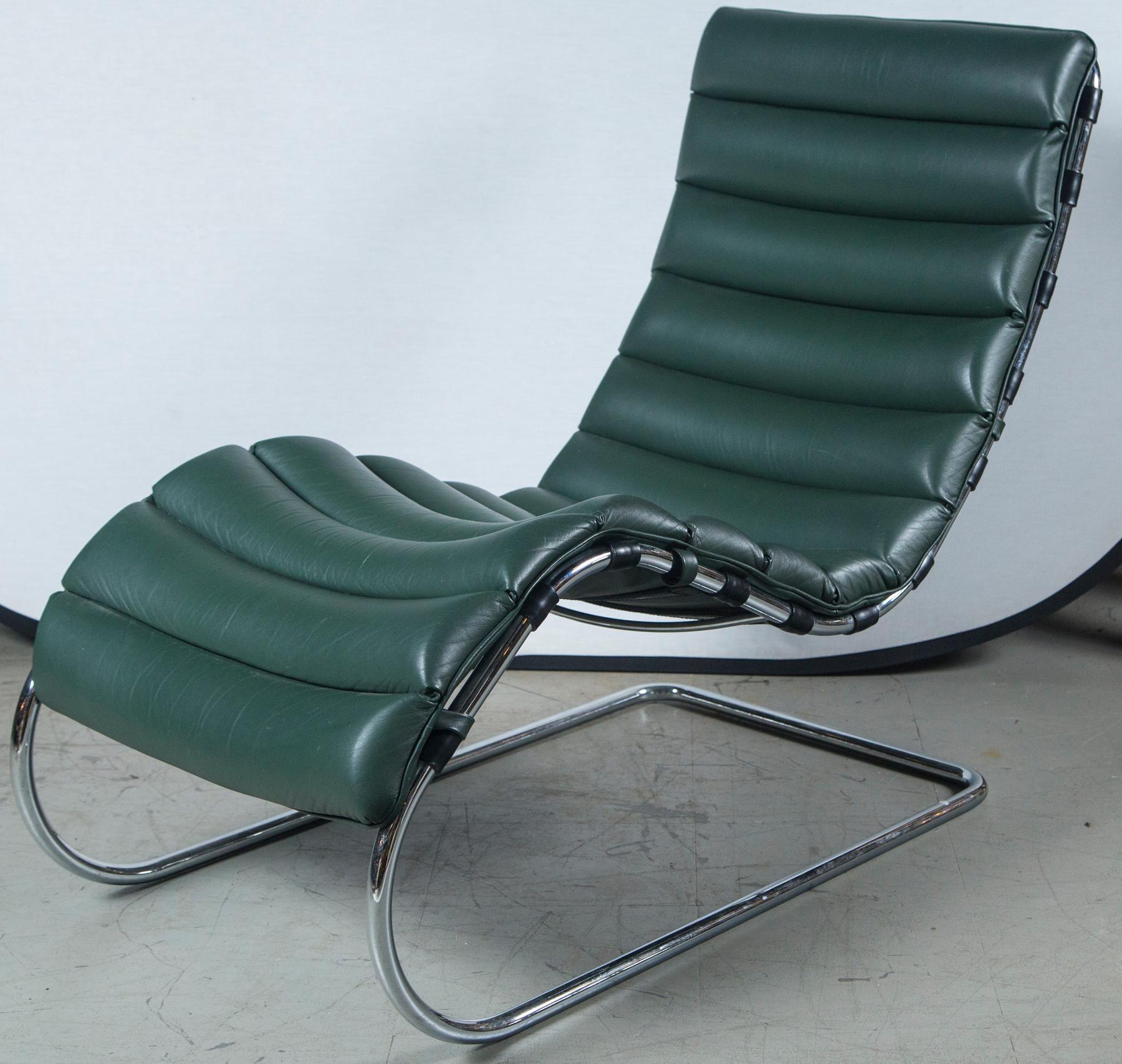 A very fine green leather with brown leather straps underneath designer lounger chair, circa 1970. Having a fastback form with deep seat area and fluid lines with firm original leather all around and a nice springy feel when sat it. A museum quality