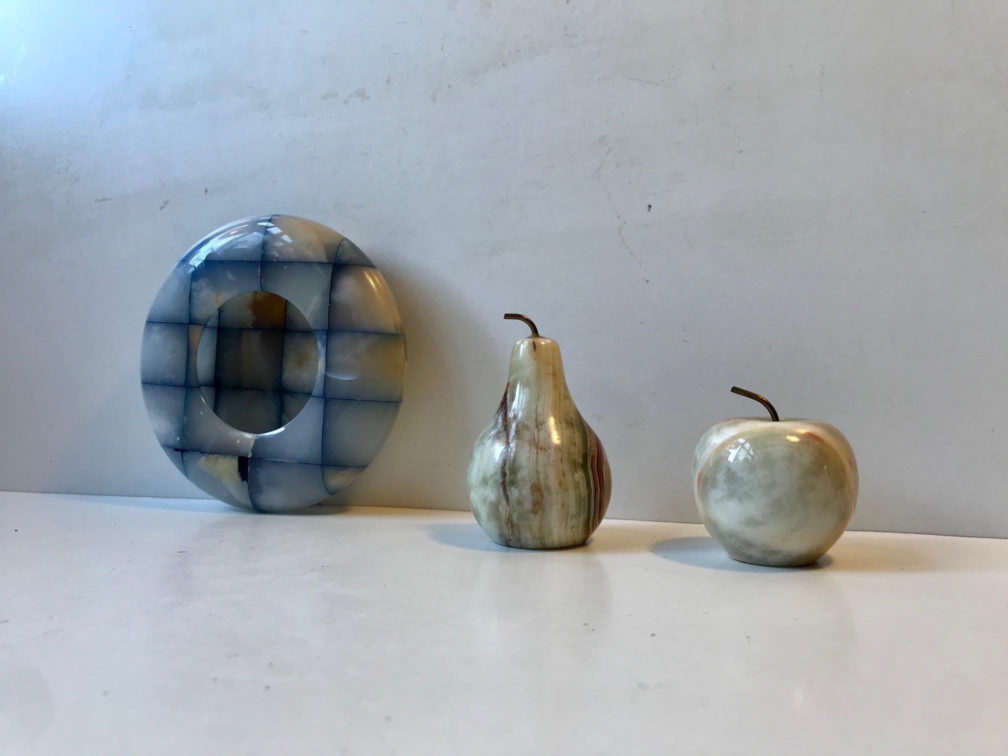 A decorative desk lot consisting of pear and able shaped paperweights with brass stems and a mosaic ashtray in Onyx marble. Manufactured in Italy during the late 1950s.