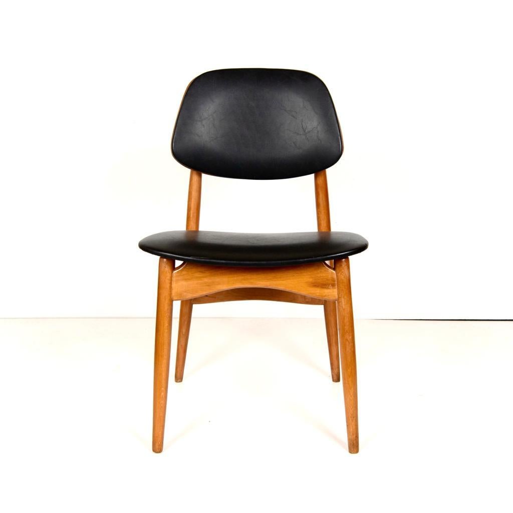 Vintage balck dining cahirs. 
A set of four 1960' s Mid-Century Modern italian design chairs with solid beech frame and leathereet black cover. Rare shape seat with beautiful woood strcuture. 
Attributed to Anonima Castelli Bologna, typical 1960's