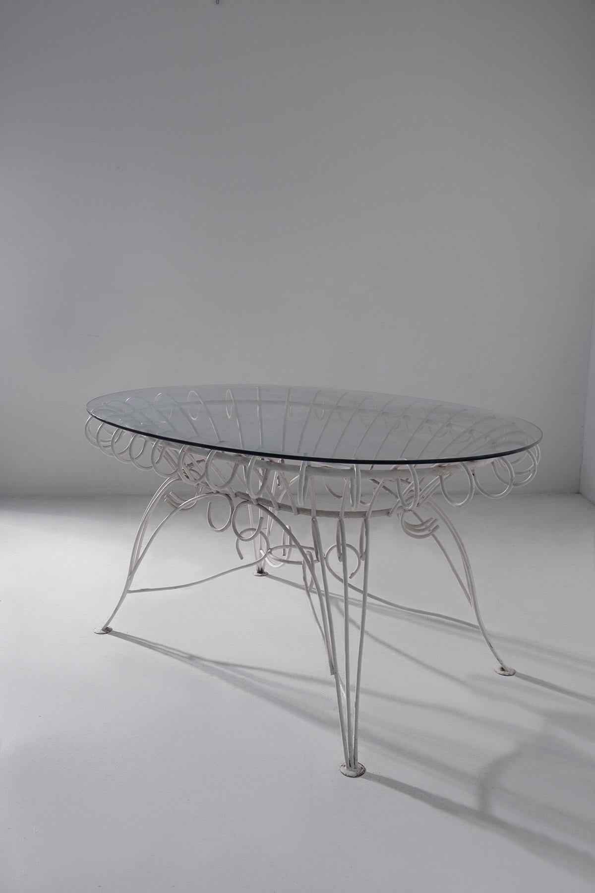 An exquisite example of mid-century Italian outdoor design, this elegant wrought-iron garden table was presented at the 1968 Milan Trade Fair, one of the most important showcases of Italian craftsmanship at the time. Archival photos from the Milan