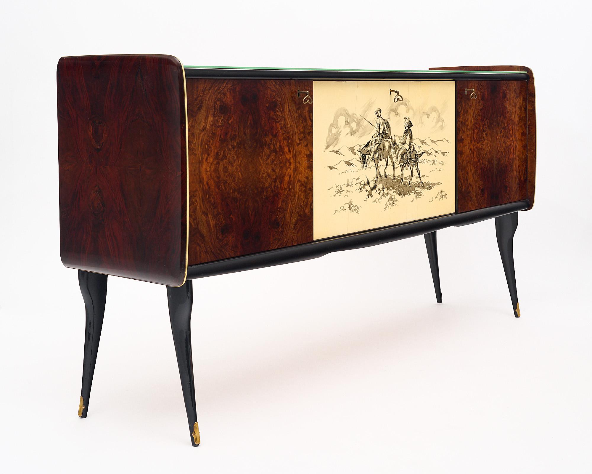 Buffet from the mid-century in Italy. This piece has two outer doors with a lovely burled veneer; while the central panel showcases a replication of an etching from Cervantes’ Don Quixote. We love the unique imagery and the striking decorative