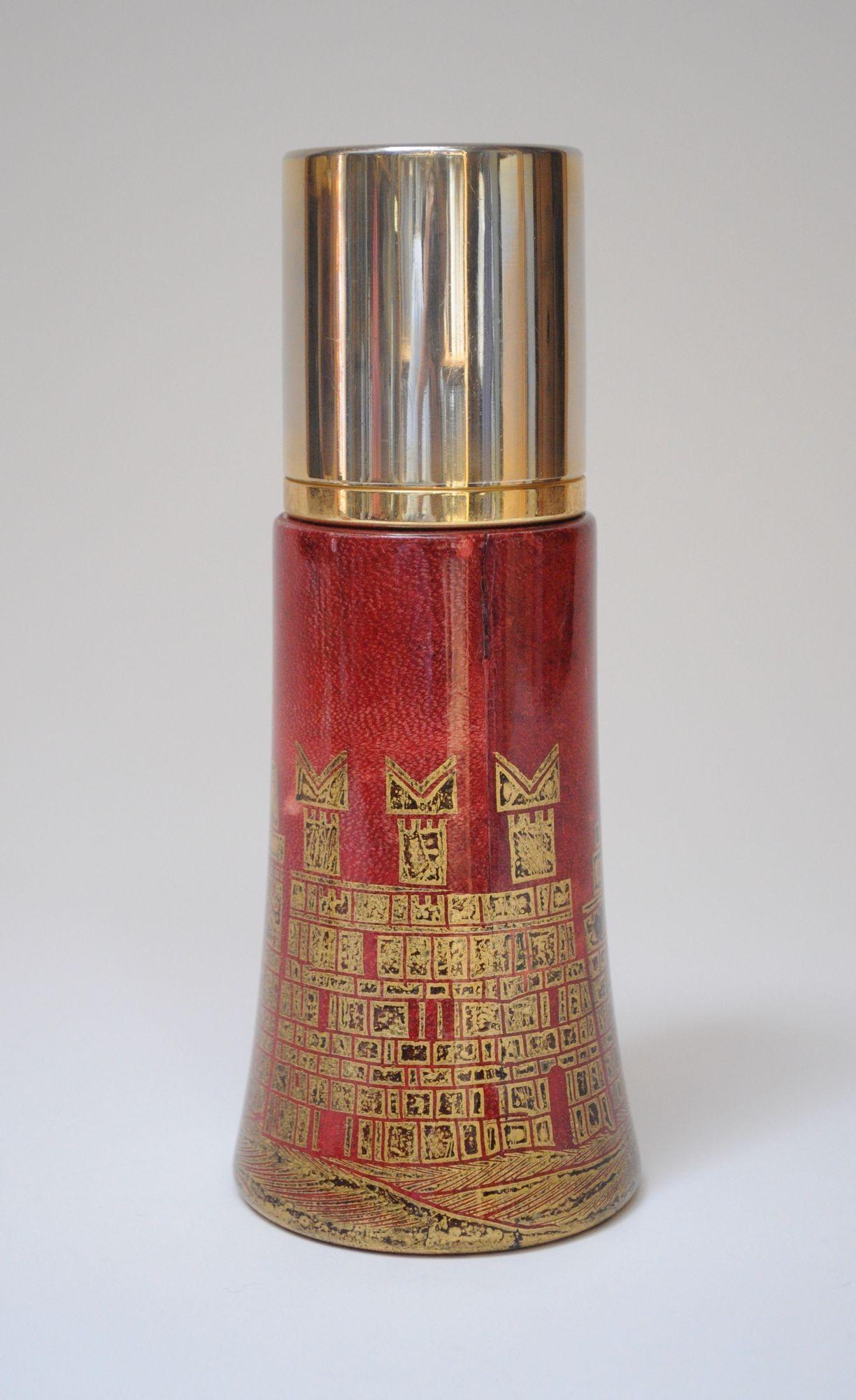 Aldo Tura Shaker/Thermos (ca. 1950s, Italy).
Composed of a hollow wooden exterior wrapped in dyed red goatskin with gilt inlay finished in a clear acrylic. Features a stainless steel interior and brass-plated stainless steel top.
Uncommon