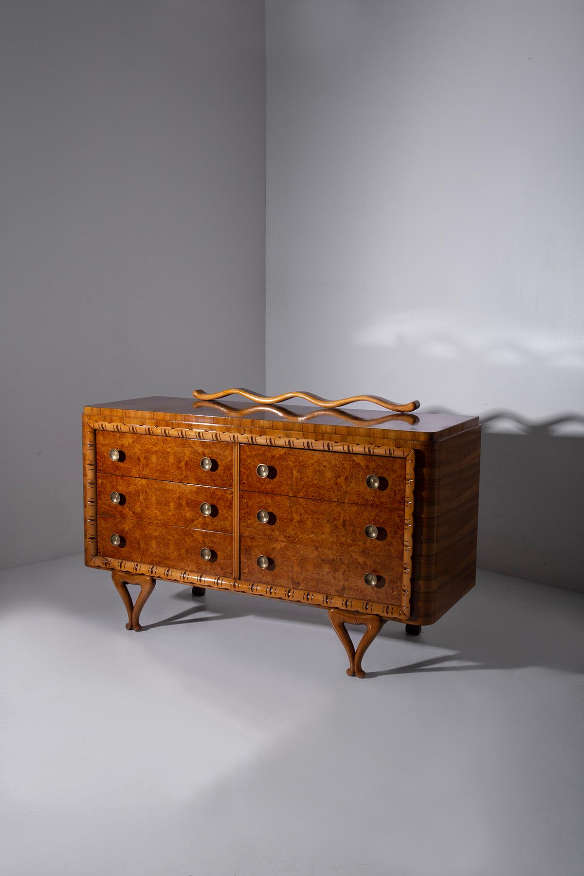 Enter the enchanting world of Italian craftsmanship from the 1950s, where every piece of furniture was a work of art, and elegance was paramount. This exquisite Italian chest of drawers, attributed to the legendary Paolo Buffa, is a testament to the