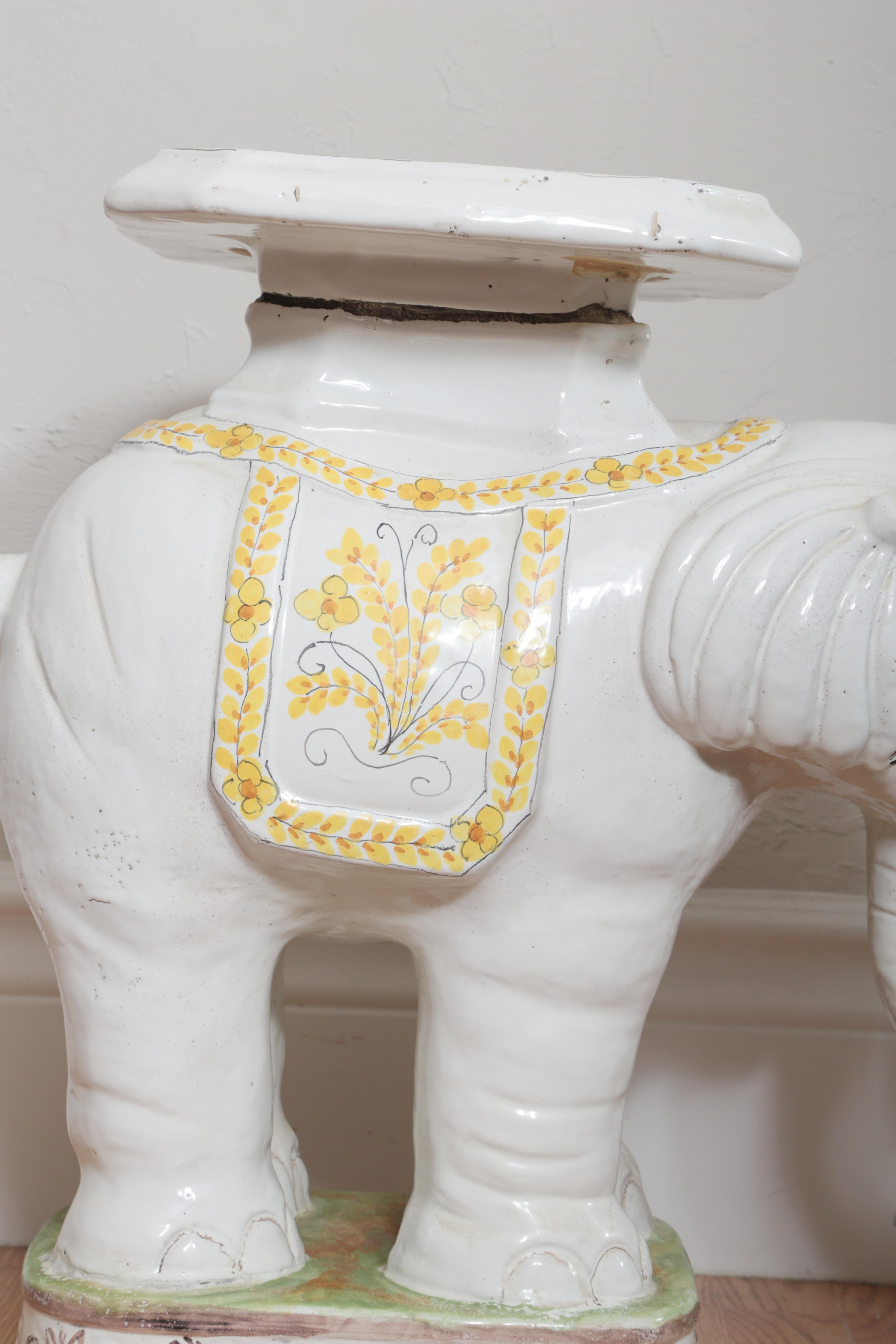 Vintage white glazed terra cotta elephant garden seat with trunk facing upward.
Made in Italy.
