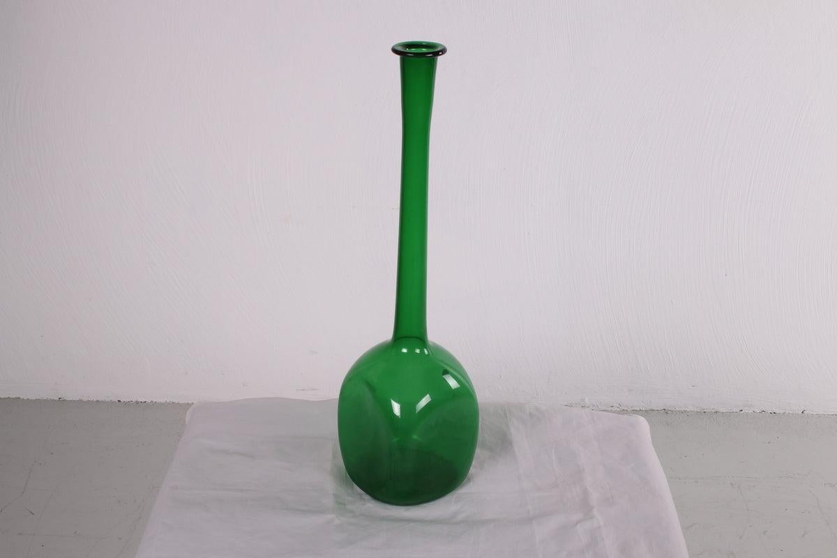 Vintage Italian Empoli Green Glass Bottle, 1950s

A beautiful deep green colored glass bottle from the 1950s.

The bottle has a dramatic long neck and a square base with rounded corners. It will look beautiful with a few flowers in it as a vase or