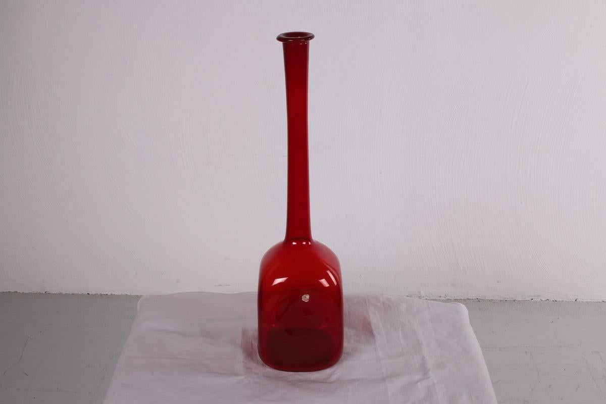 Vintage Italian Empoli Red Glass Bottle, 1950s

A beautiful red colored glass bottle from the 1950s.

The bottle has a dramatic long neck and a square base with rounded corners. It will look beautiful with a few flowers in it as a vase or on its own