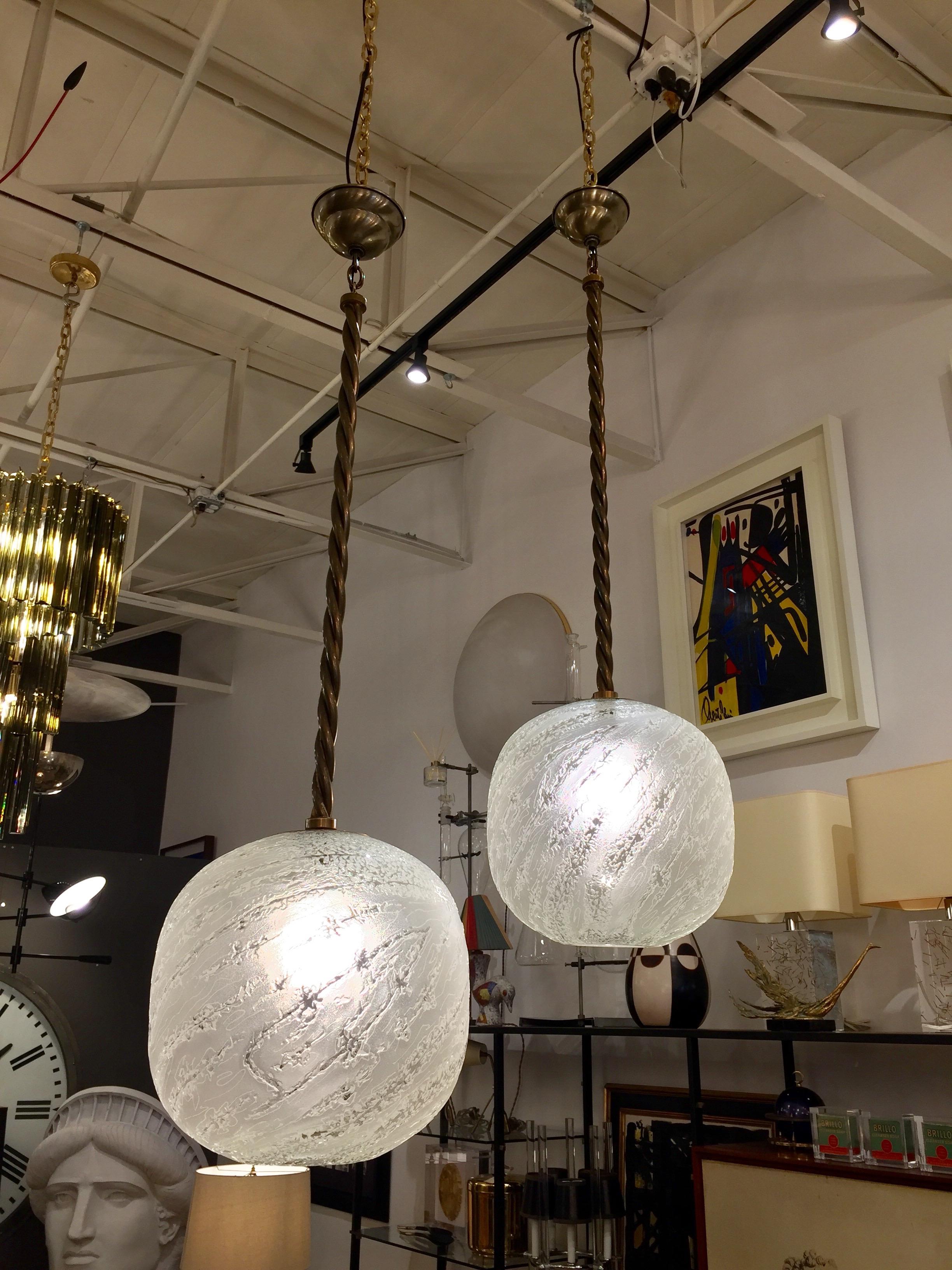 This Murano glass globe pendant light has thickly etched frosted glass and beautiful finish work at opening. Original twisted brass rod and canopy.