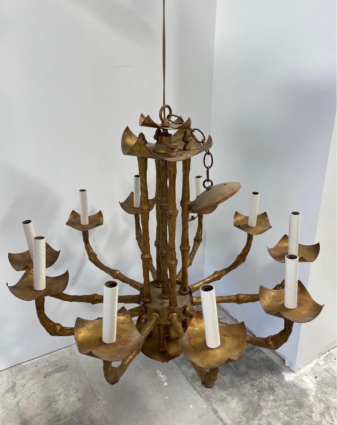 A great vintage Italian chandelier in faux bamboo chinoiserie form, 10 light, pagoda style and gilded. Fully operational, Cap measures 5”.