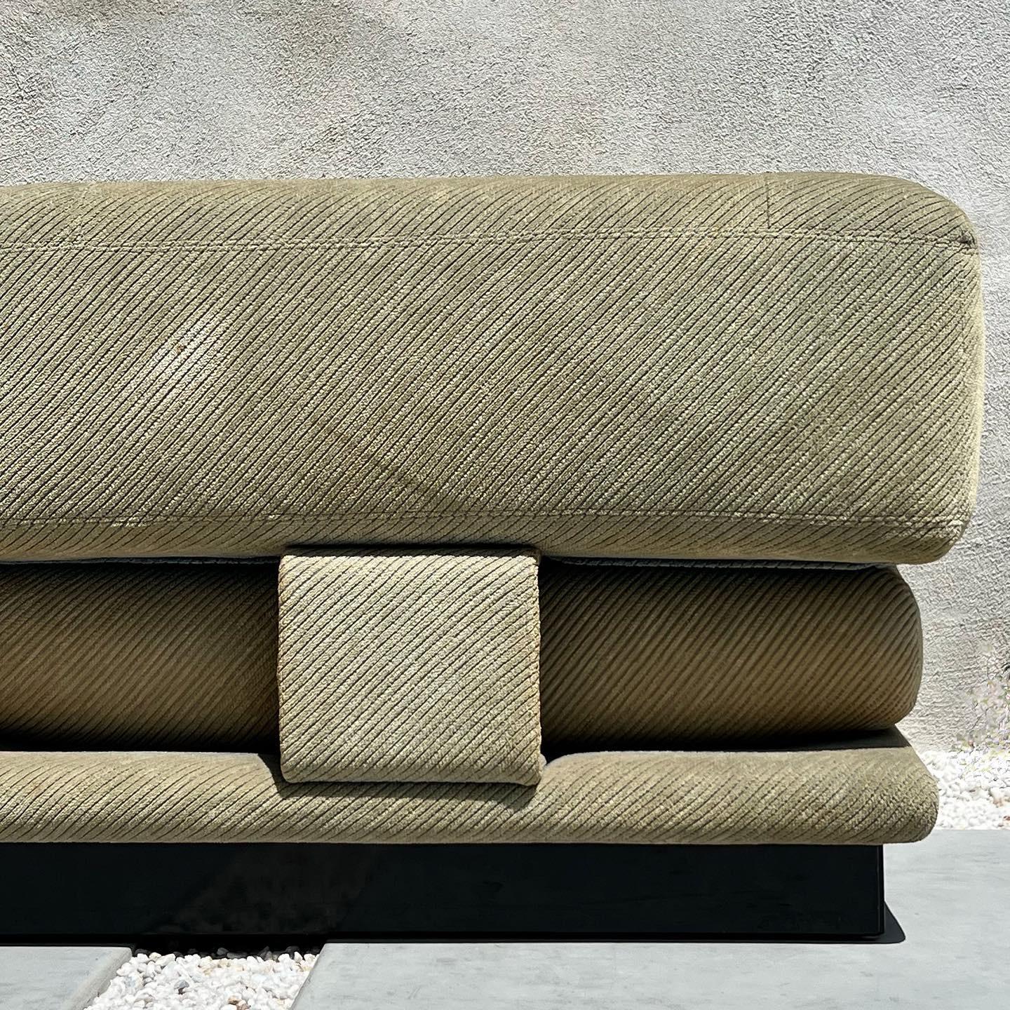A high-end vintage Italian modernist sofa by Saporiti Italia, circa 1970s. Textured sage green velour upholstery is original and in wonderful condition with minor signs of age. The sofa itself is suspended on a lacquered wooden plinth, giving it the