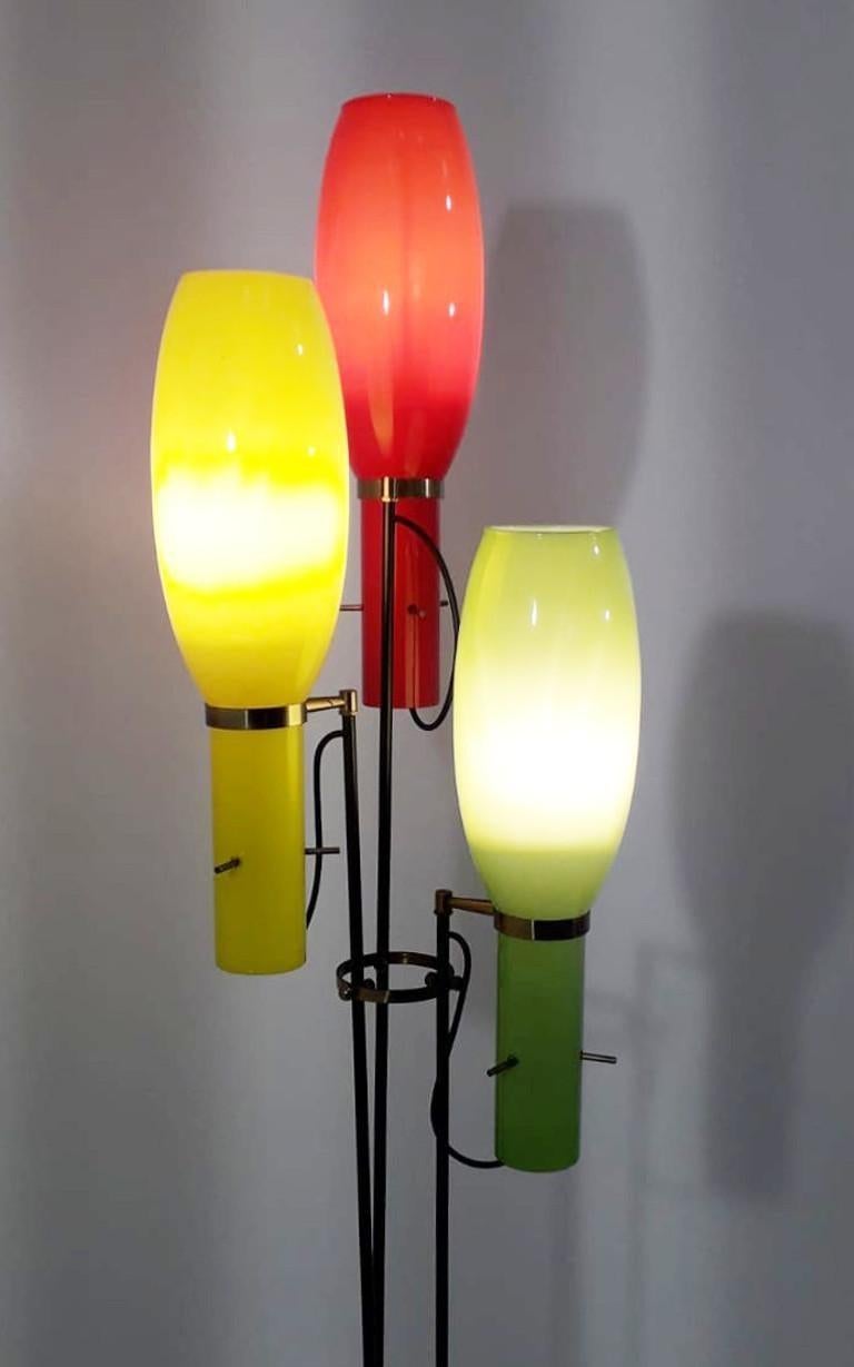 Vintage Italian floor lamp with three Murano glasses hand blown with white interior and red, yellow, and light green exterior using Incamiciato technique, mounted on painted black metal legs, brass details and marble base / designed by Vistosi,