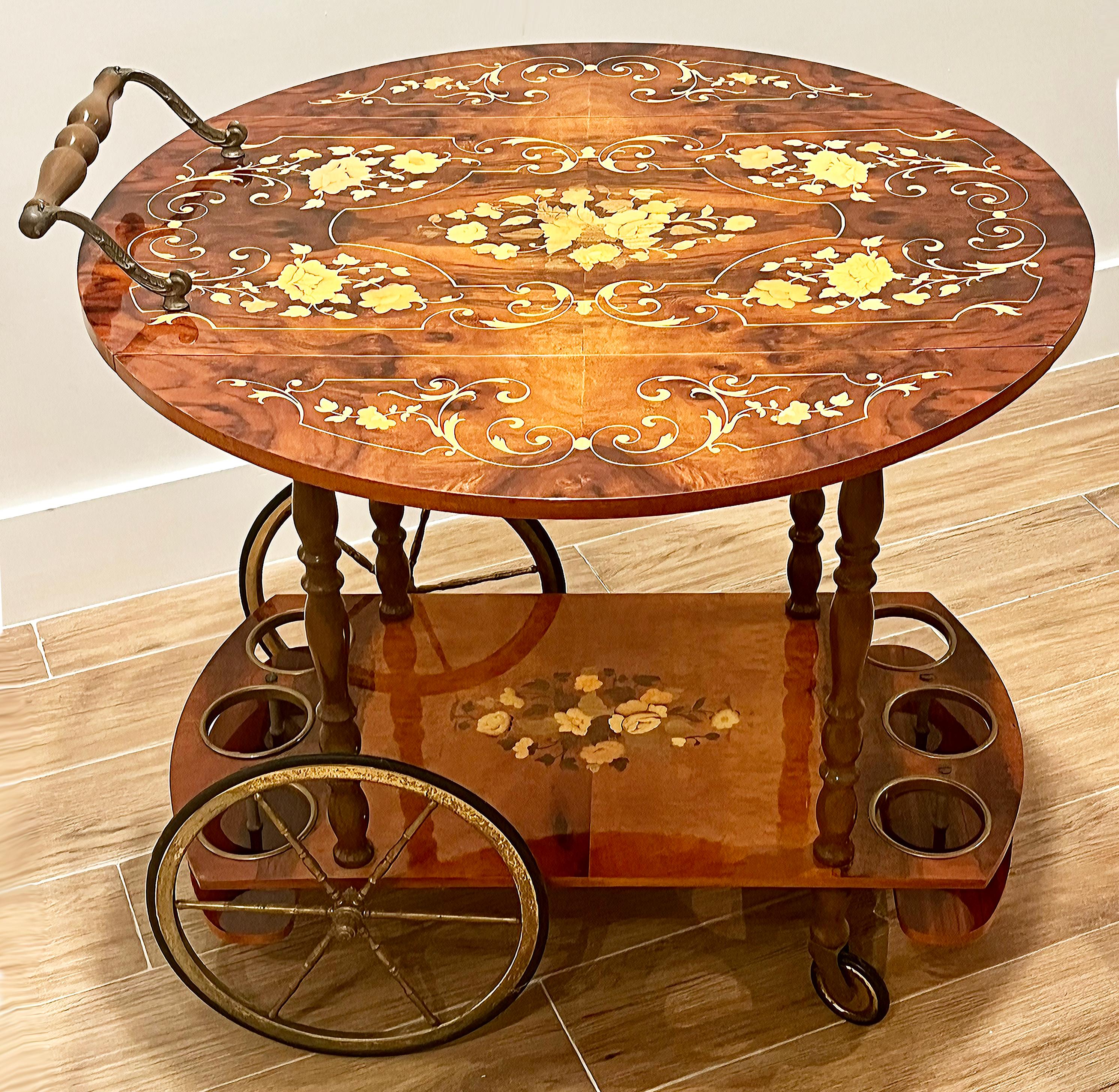 Vintage Italian Floral Inlay Rolling Bar Tea Cart, Drop Leaf Sides

Offered for sale is an Italian floral inlay marquetry bar cart with drop leaves that can be raised and locked to extend the top.  The cart has brass hardware, a wooden handle, and