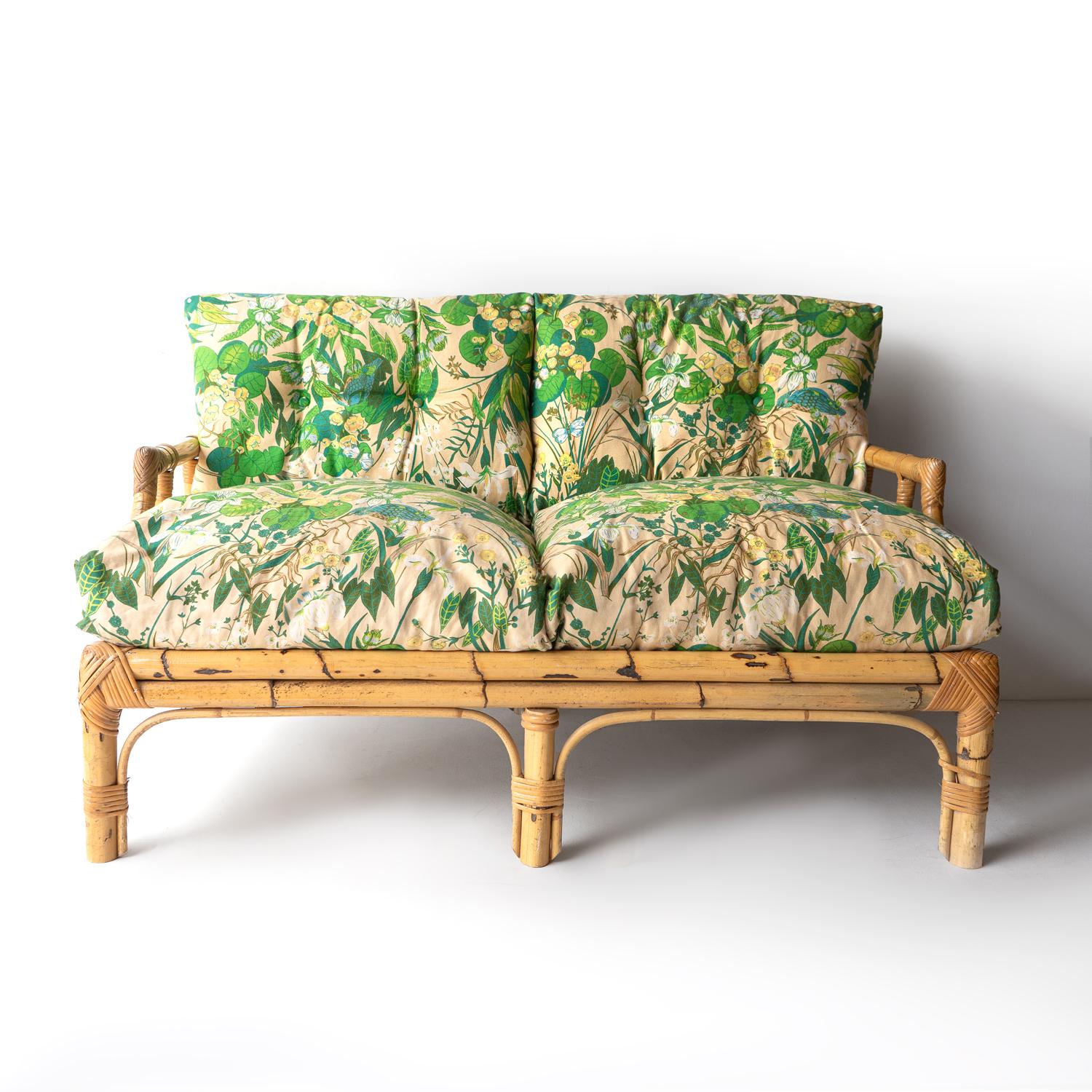 MID-CENTURY TWO SEATER SETTEE 
By renowned Roman luxury furniture maker Vivai del Sud and dating from their 1970s heyday.

Extremely well made from bamboo and rattan in signature geometric patterns.

Original jungle-themed floral upholstery with