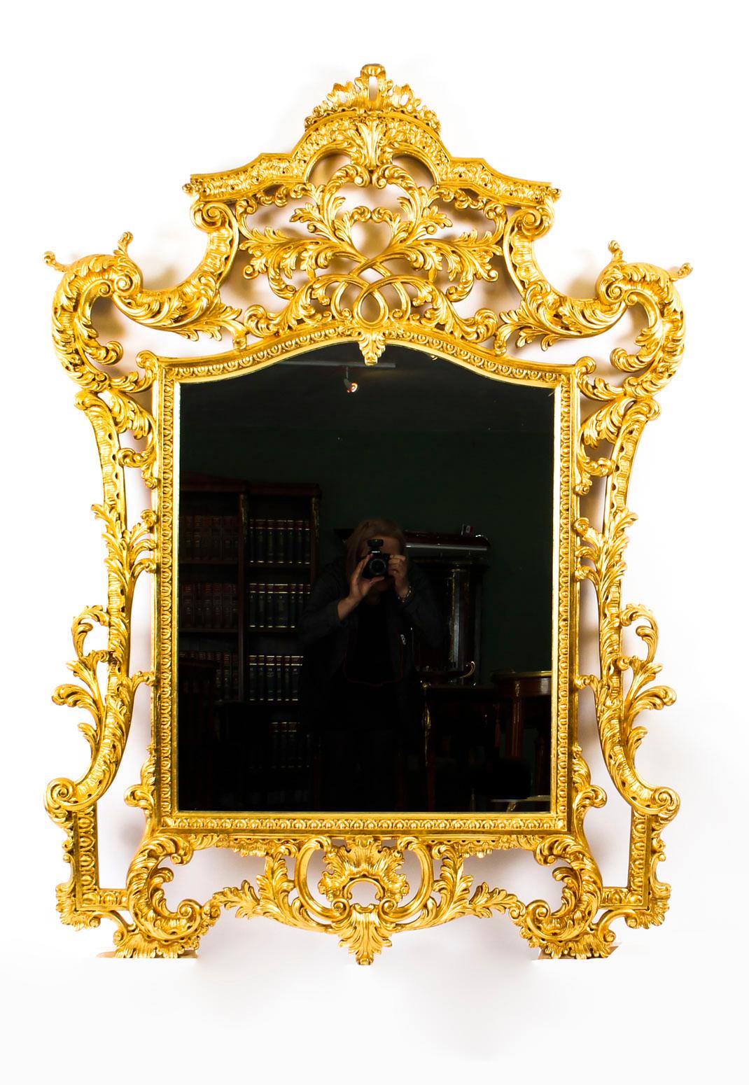 This is a stunning Italian Florentine carved giltwood mirror, dating from the late 20th century.

The mirror plate is within a boldly-carved and pierced scrolling foliate frame within an egg and dart border. 

This is a very decorative item which