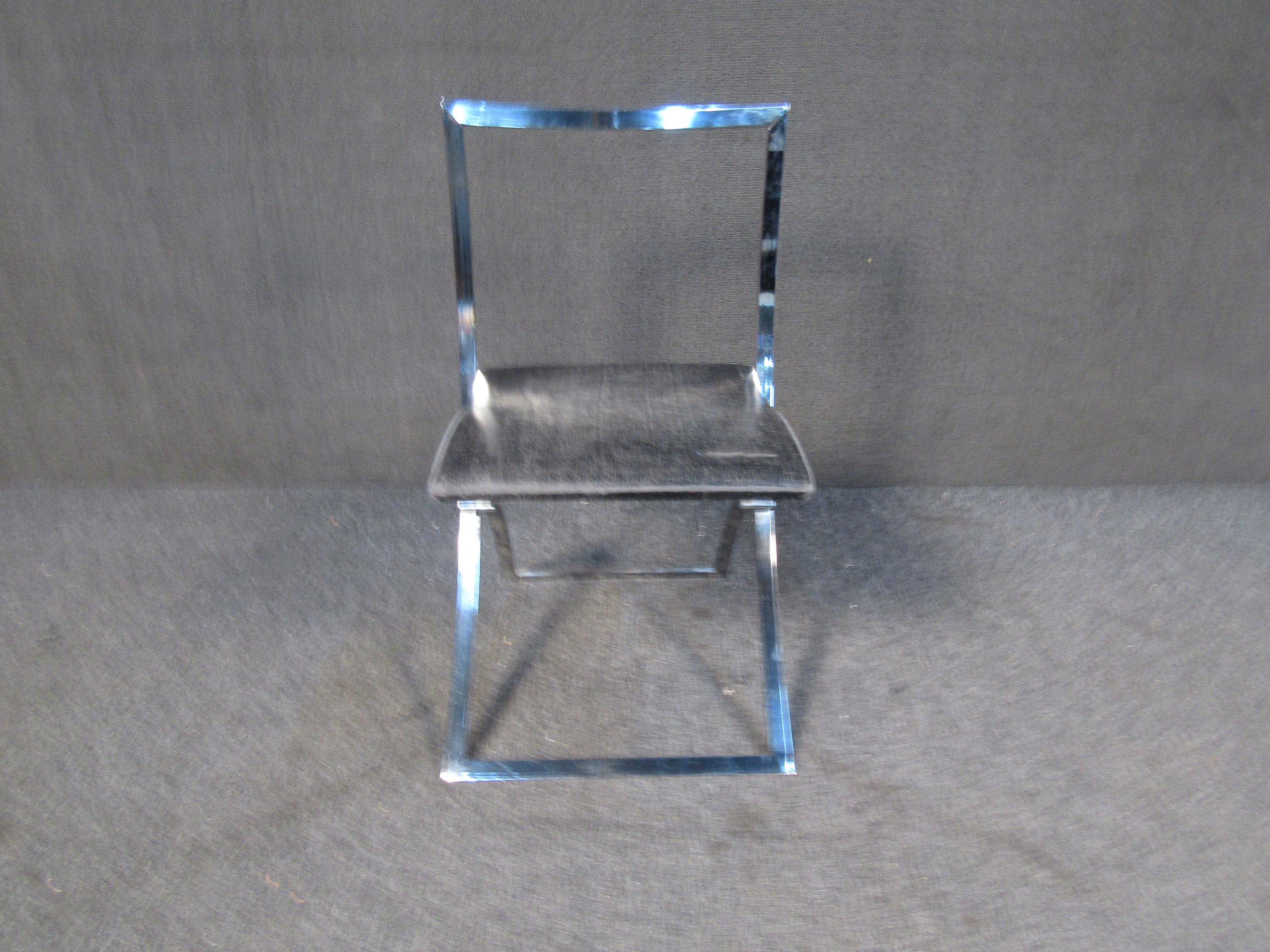 With an elegant frame, upholstered seat, and bright chrome finish, this vintage Italian folding chair offers style in a compact design. Please confirm item location with seller (NY/NJ).