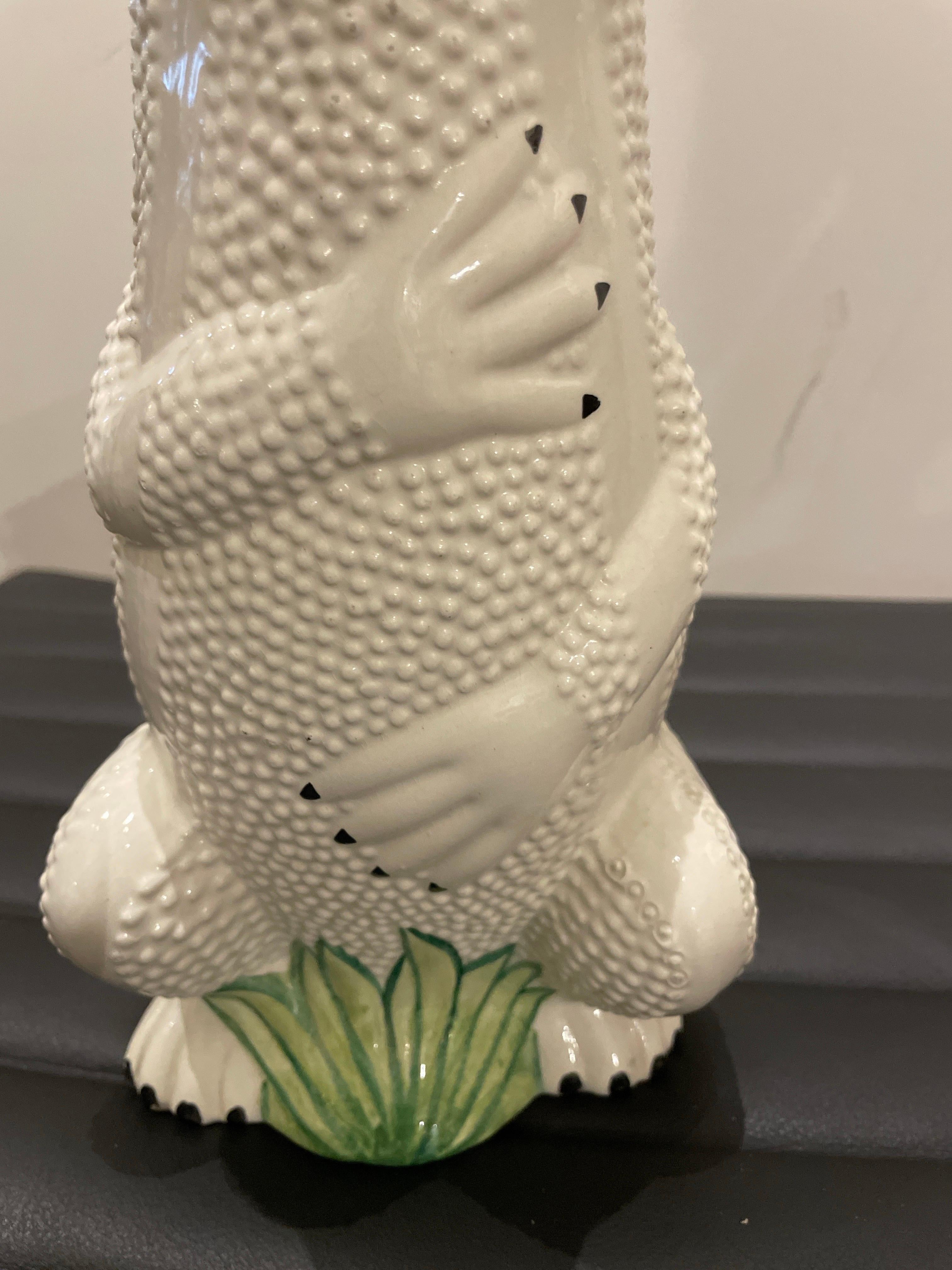 Wonderful and whimsical Italian Gecko pitcher. All hand painted and glazed in a white dimpled background with green accents and big black eyes. A rare piece.