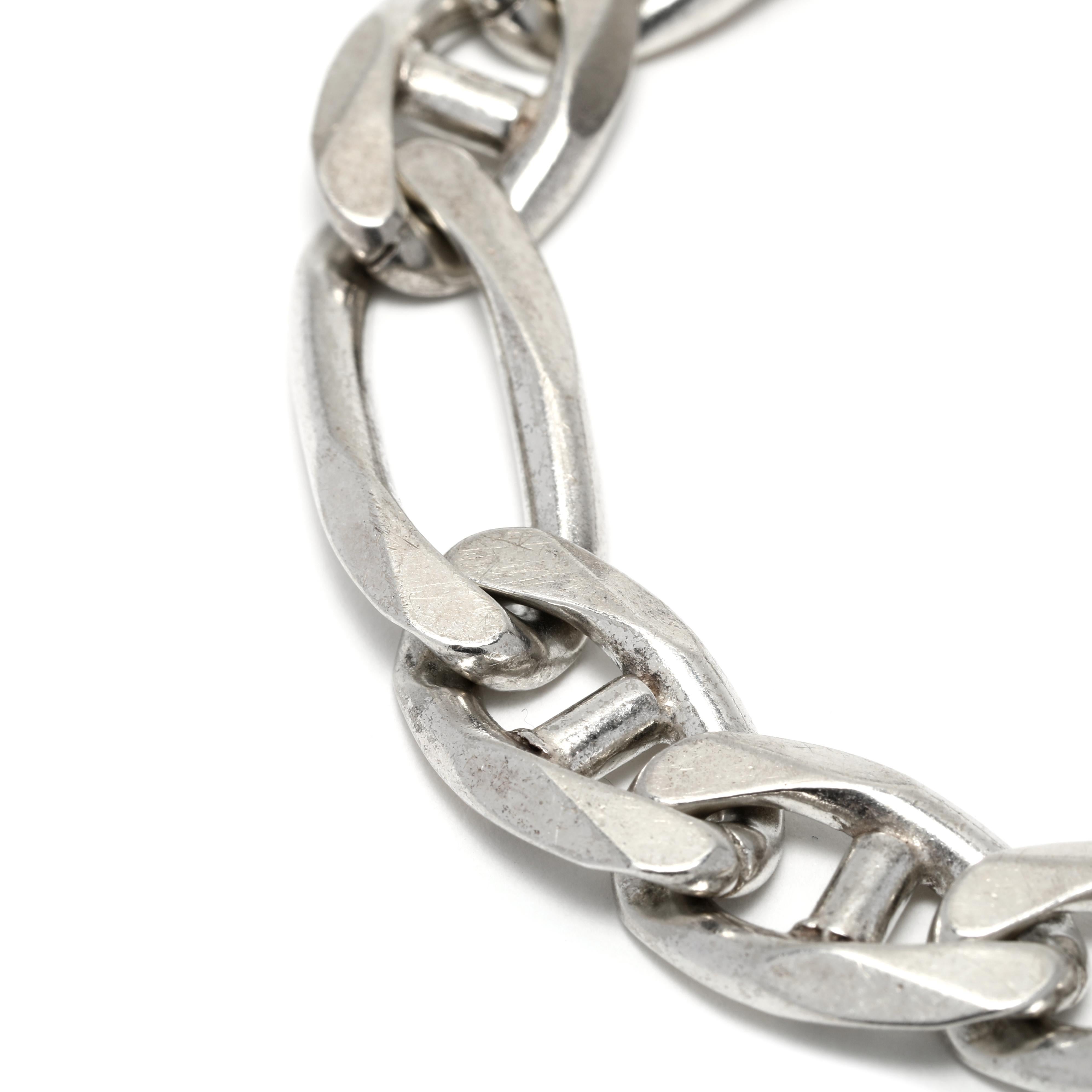 This vintage Italian Gent's Figaro Link Bracelet is the perfect everyday accessory. Crafted of sterling silver, this large Figaro bracelet has an impressive length of 7.75 inches. The intricate Figaro links create a classic look that will never go