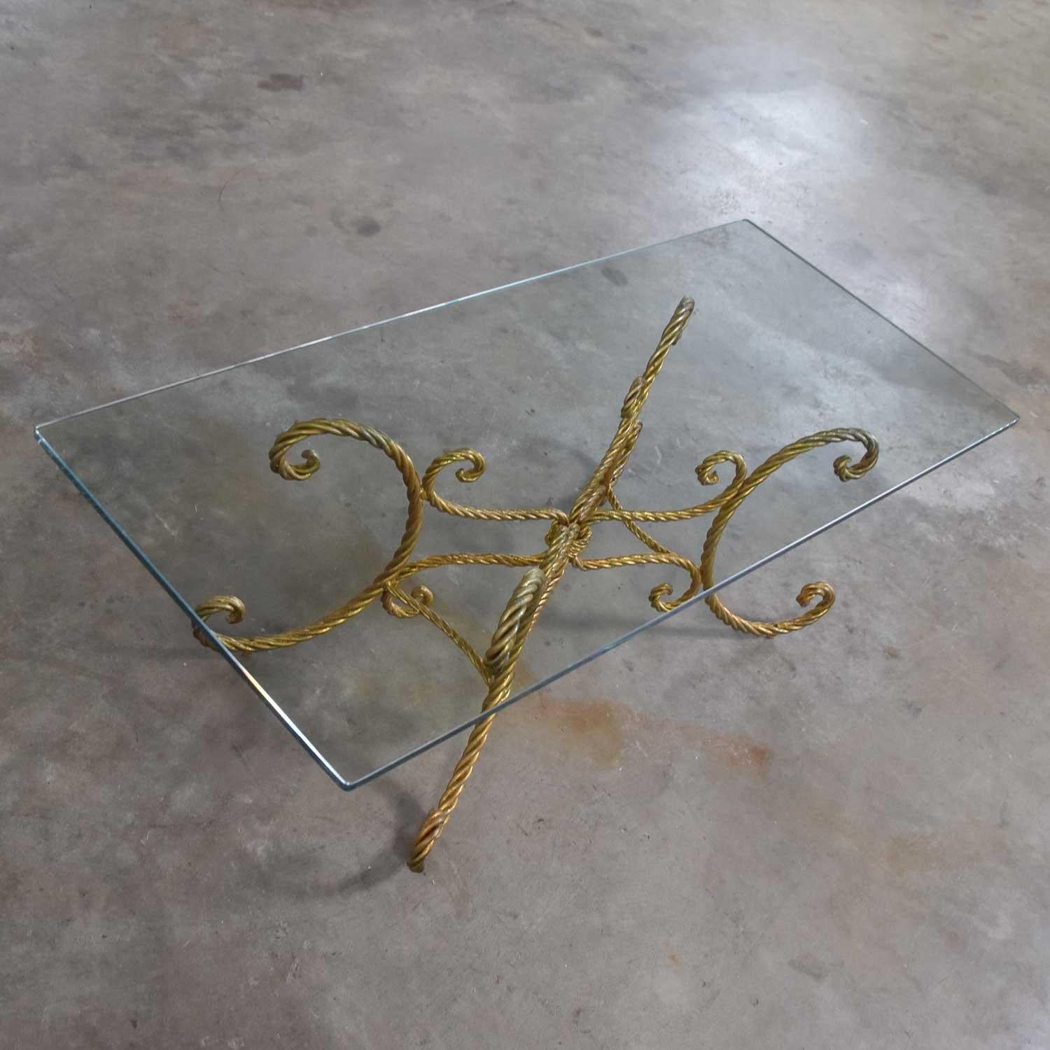 Splendid vintage Italian gilded twisted iron rope coffee table with rectangle glass top. Fabulous vintage condition. The base has had some touch up and the glass top is free of chips. Please see photos, circa midcentury.

 


This coffee table