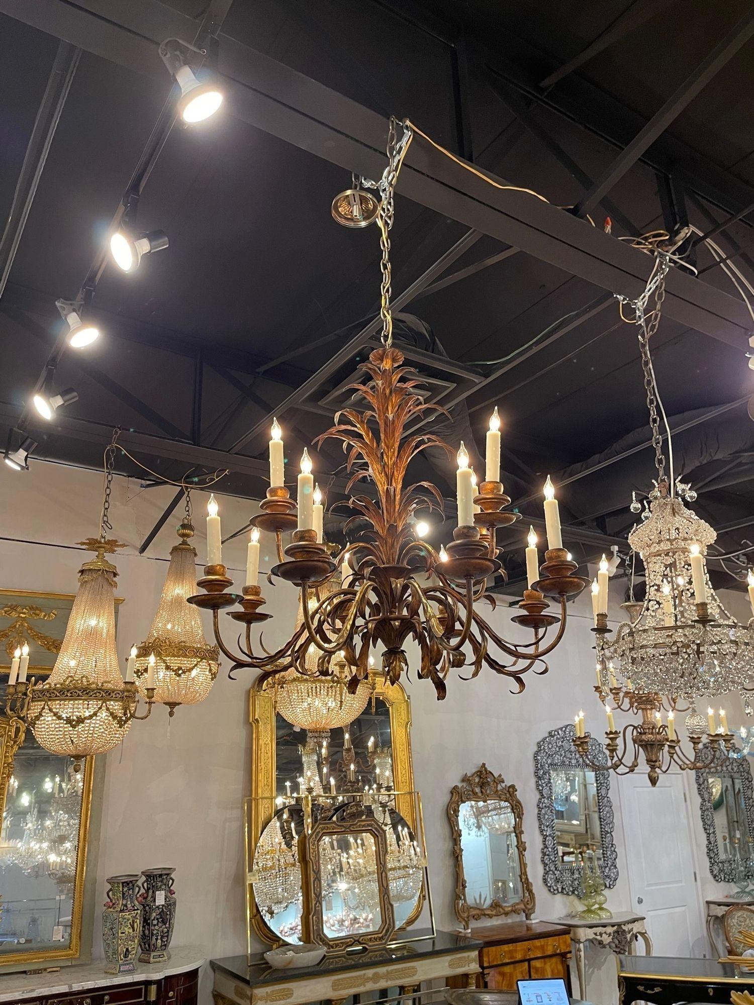 Very fine vintage gilt metal leaf form chandelier with 12 lights. Featuring cascading gold leaves on the base and curved arms. Makes an impressive statement!