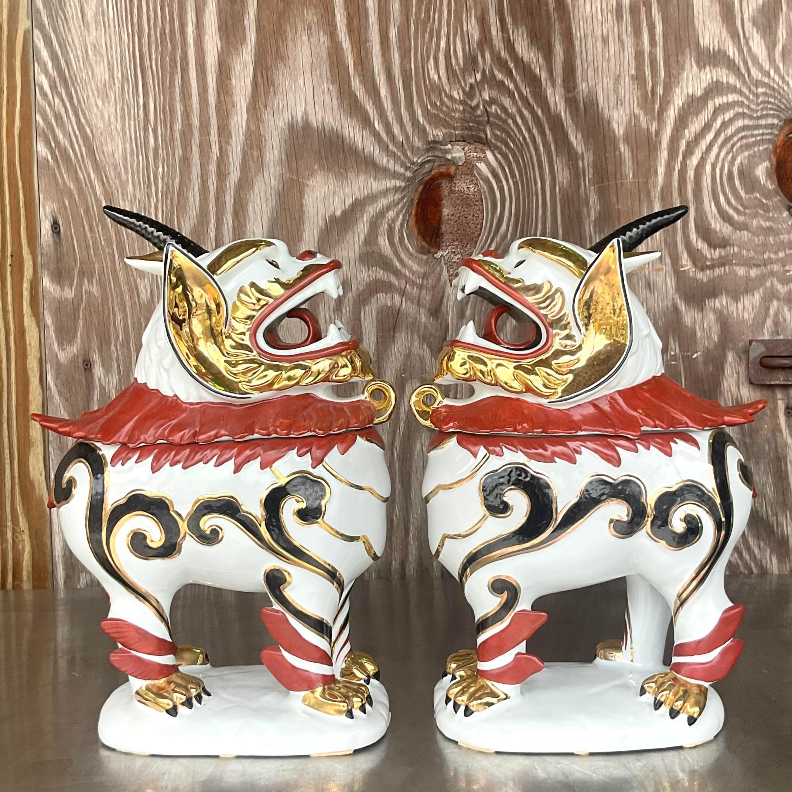 A striking pair of vintage lidded Asian Foo dogs. A chic hand painted porcelaine with gilt tipping. Lots of great secret storage for the family jewels. Made in Italy and marked on the bottom. Acquired from a Palm Beach estate.