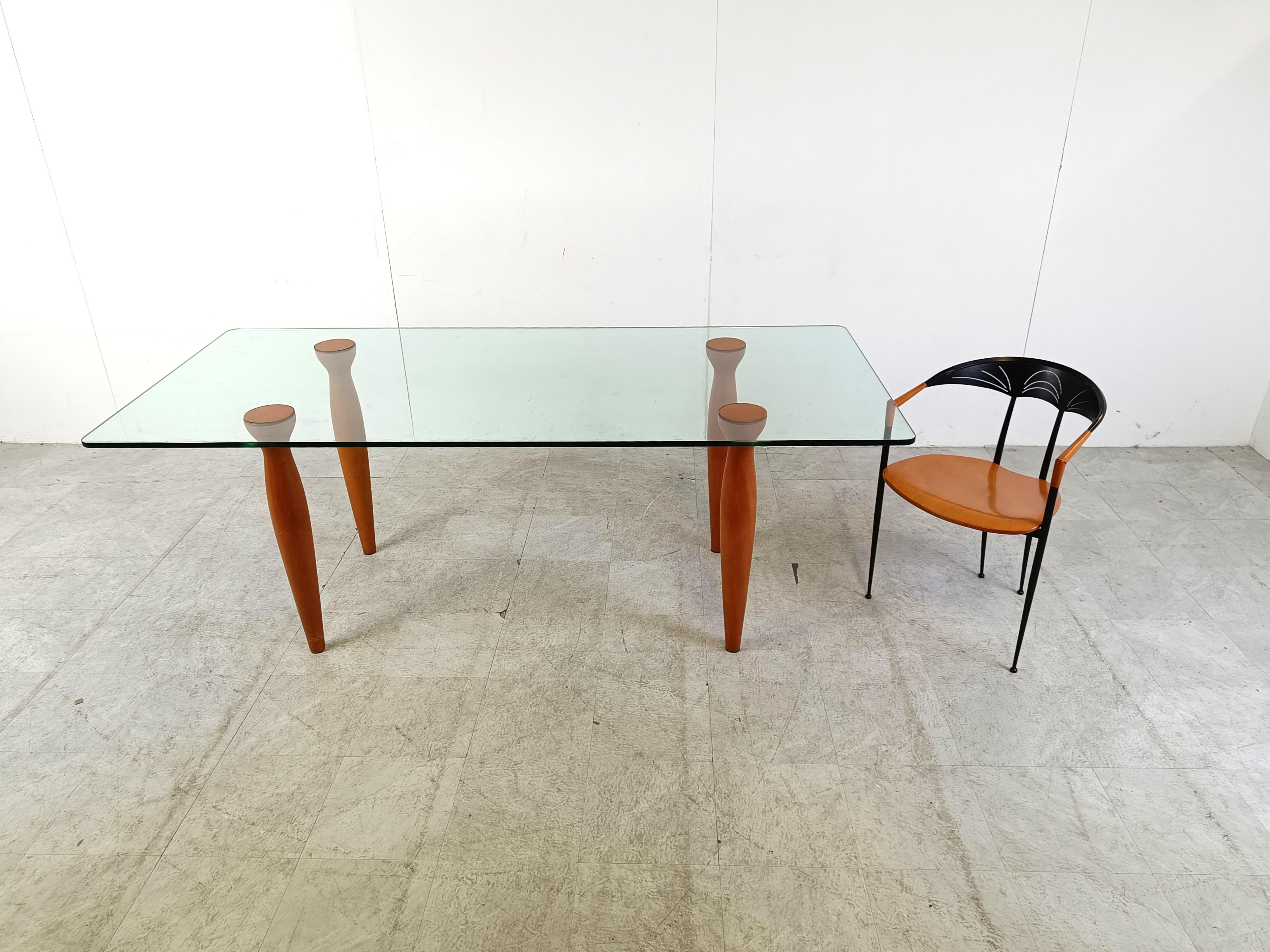 1990s italian design dining table consisting of a clear glass rectangular top with 4 elegant sculpted wooden legs. 

The legs interlock with the glass.

Good condition.

1990s - Italy

Dimensions:
Height: 75cm/29.52