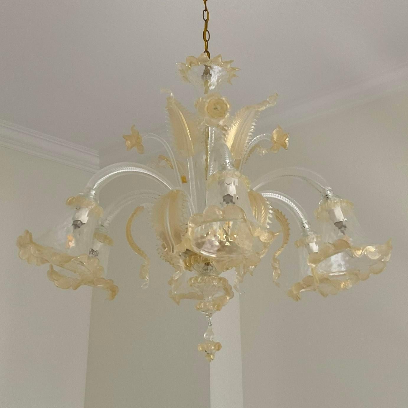 This vintage Italian glass floral chandelier, inspired by Murano, showcases exquisite craftsmanship and timeless beauty. With its intricate floral design and radiant glasswork, this chandelier adds a touch of elegance and sophistication to any room,