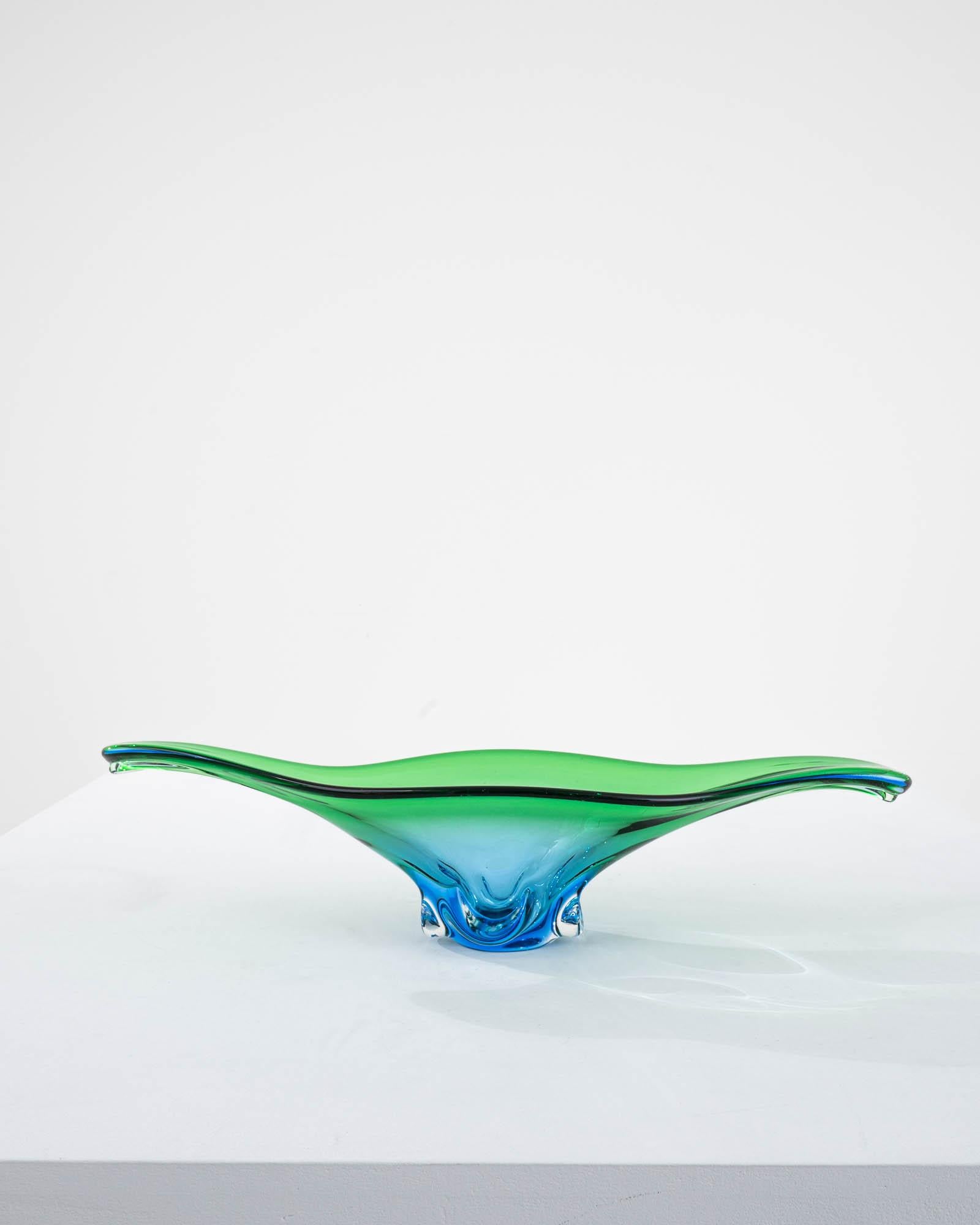 The vivid hues and liquid lines of blown art glass create an unmissable accent. Made in Italy circa 1960, expressive glasswork forms a bold silhouette. Organic and abstract, reminiscent of a water droplet captured in slow motion. A luminous gradient