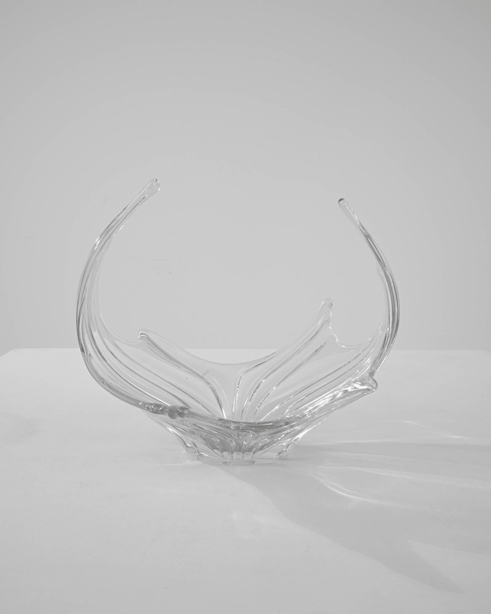 Coming from the expertise of glassmaking in Italy, this plateau is a sophisticated and gracious piece to decorate a tabletop. Following shapes inspired by nature, mimicking the flow and gravity of a fluttering leaf. As a fruit basket meant to enjoy