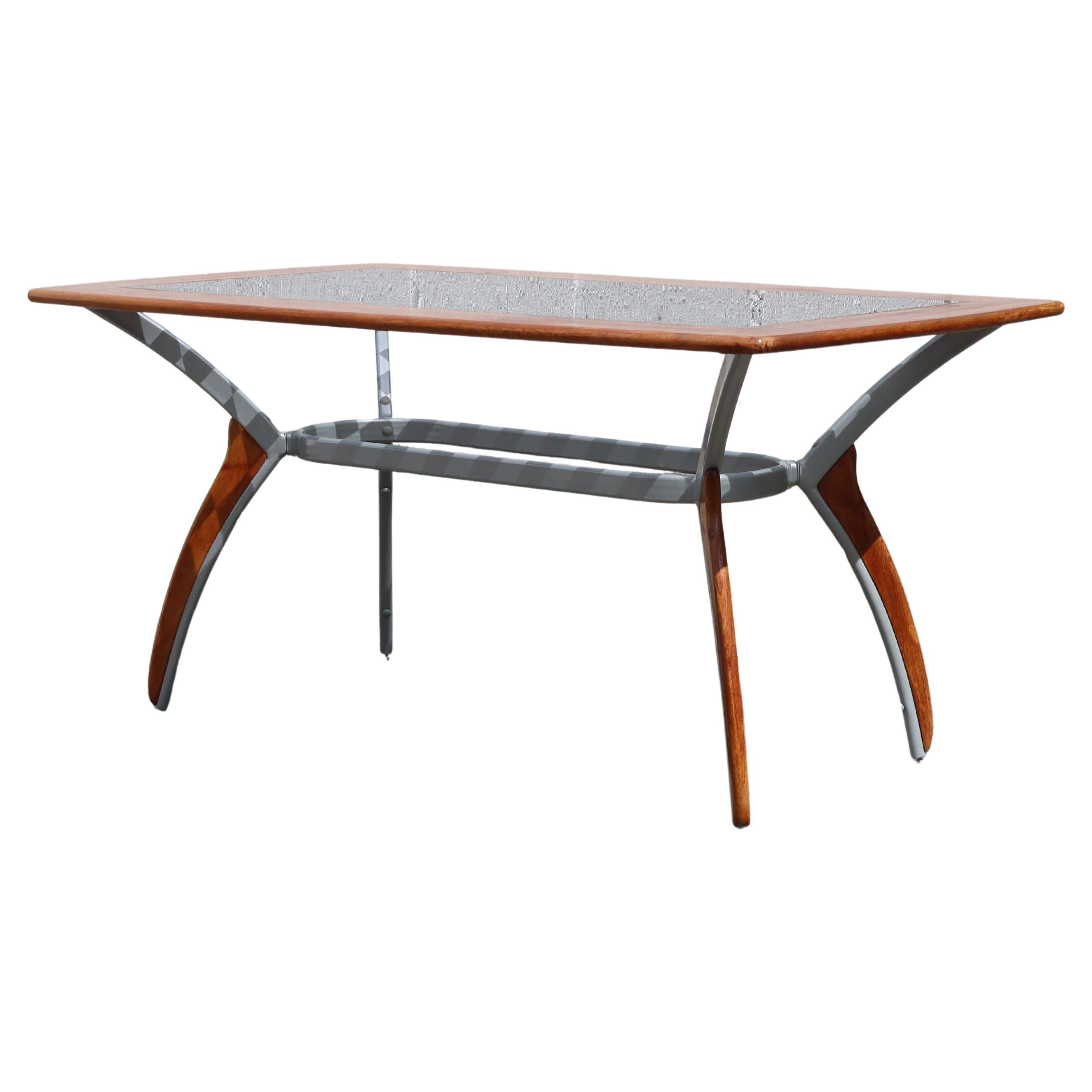 Vintage Italien Glass-Wood-Metal Dining Table from the 80s
Extravagant Design and excellent Craftsmanship characterize this Dining Table.
The tabletop is made of beechwood and features a sandblasted glass top with a checkerboard pattern.
The sturdy