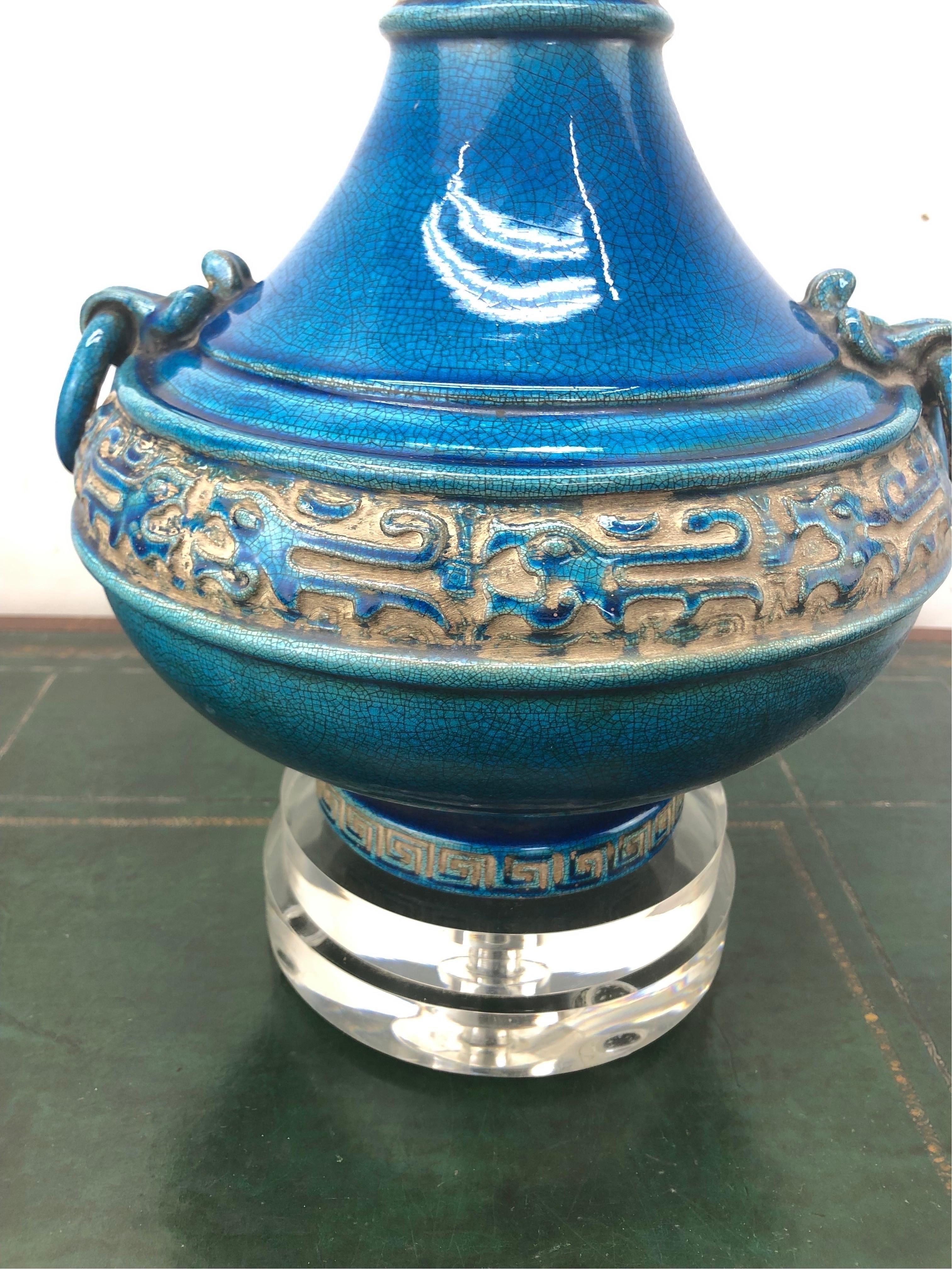 Vintage Italian Glazed Chinoiserie Crackle Turquoise Lamp. Designed to mimic buried Chinese porcelain, the vibrant turquoise crackle glaze nicely contrasts with Chinese inspired design. Mounted on a double lucite base and newly wired.