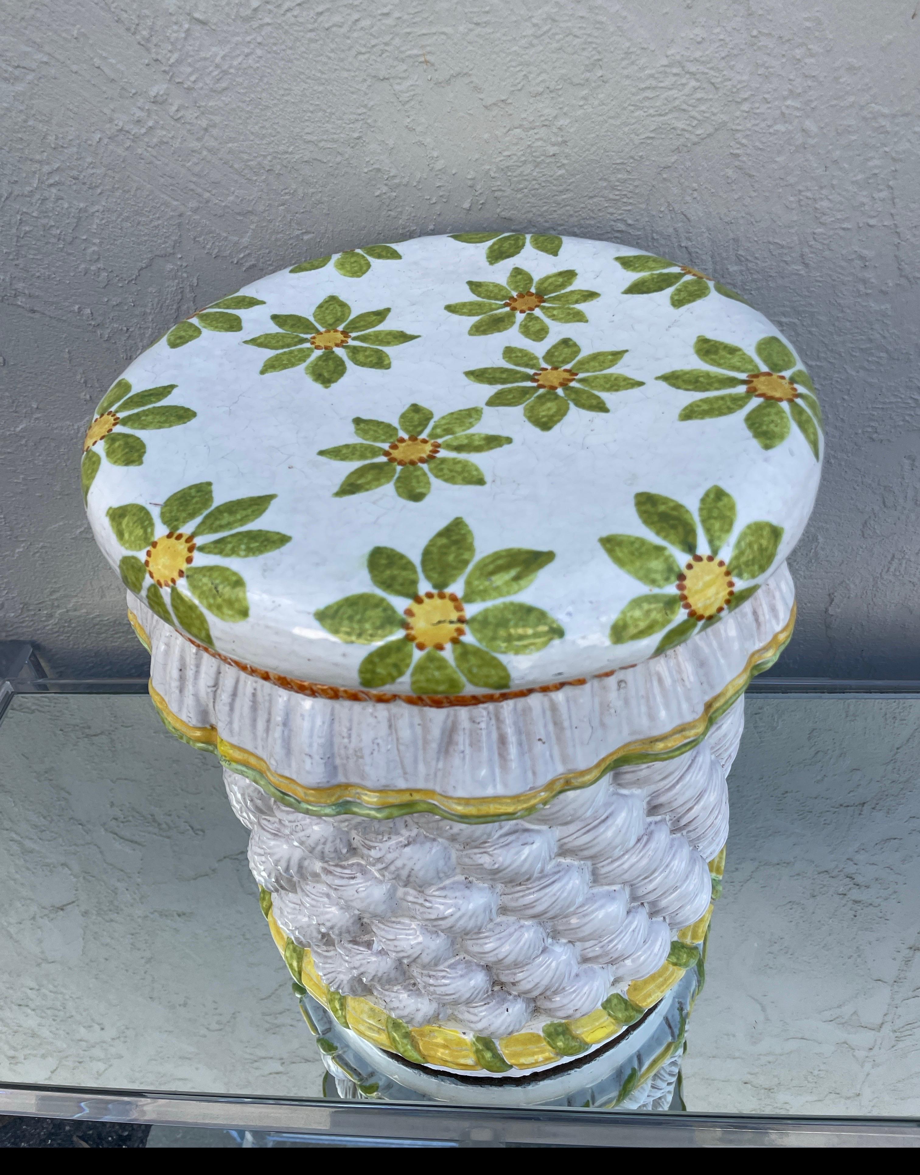 Wonderful rare Italian glazed & hand painted terracotta garden seat. Skirted top with green & yellow flowers. Sides have a raised seashell motif all around with painted designs near bottom.