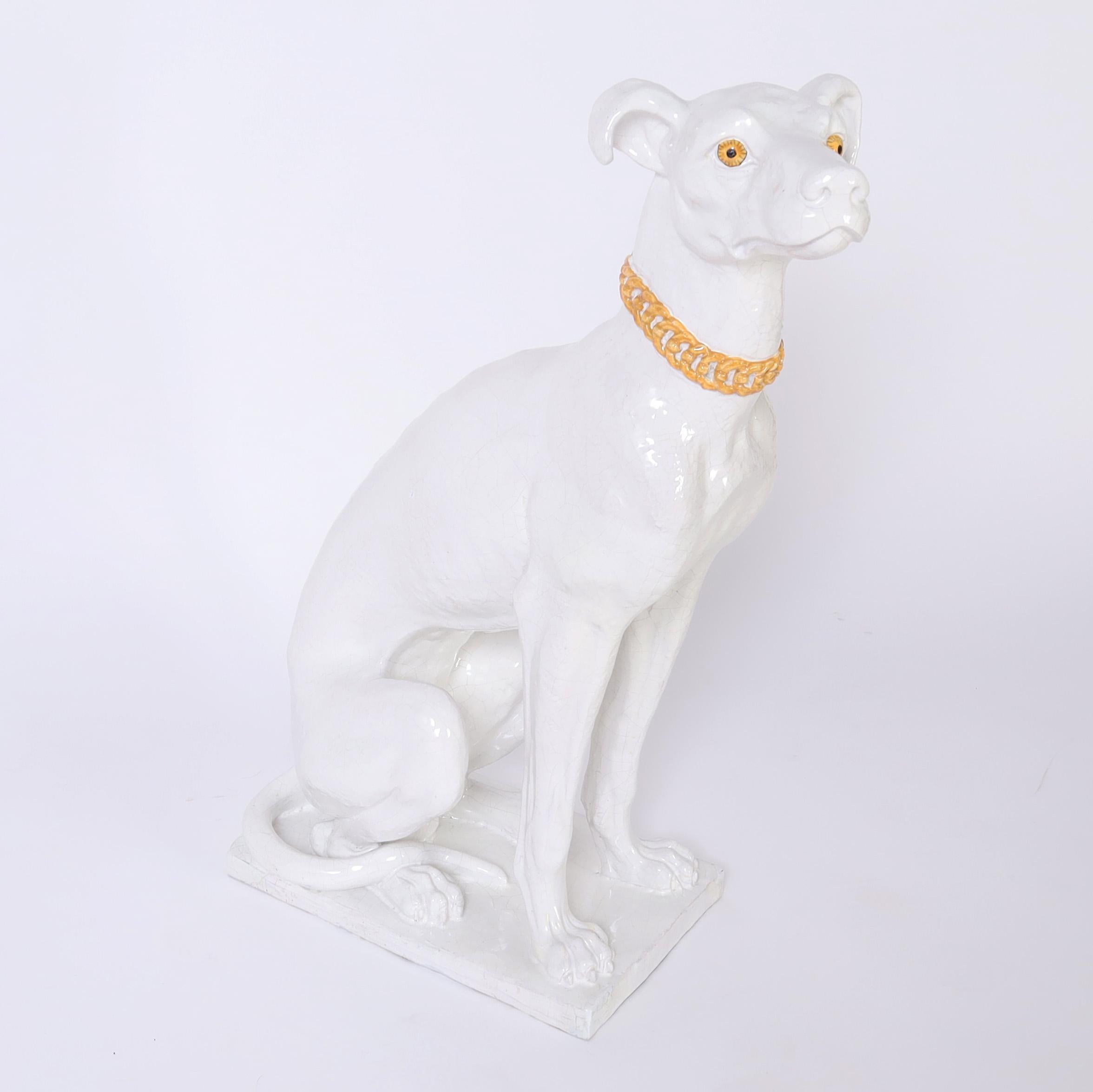 Striking Mid Century Italian life size dog sculpture crafted in terracotta with a white glaze and mesmerizing gold eyes. Marked Italy on the bottom.