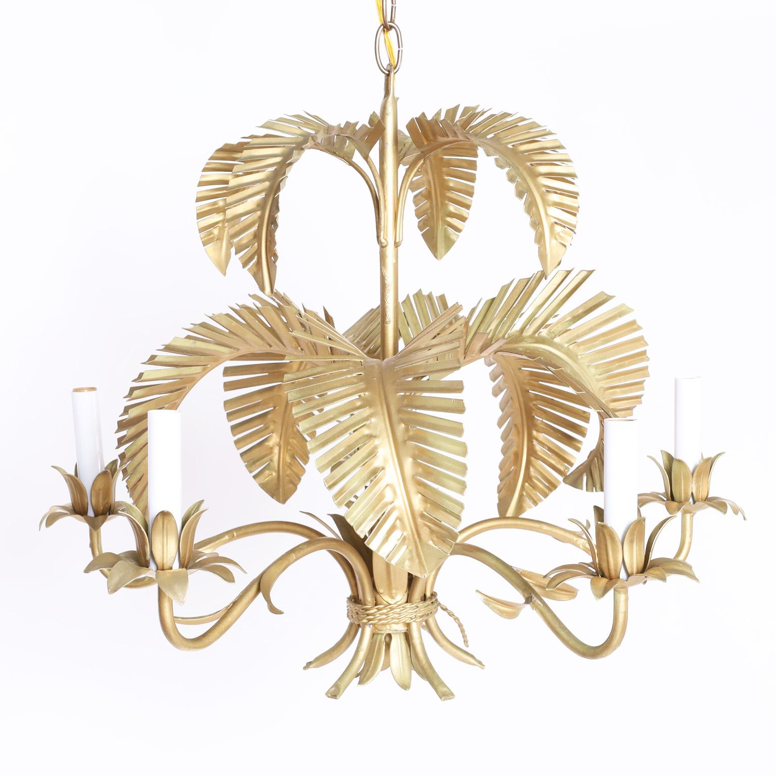 Midcentury six light chandelier with a chic gold finish over metal having a palm frond motif and leaf candle cups and bobeches.