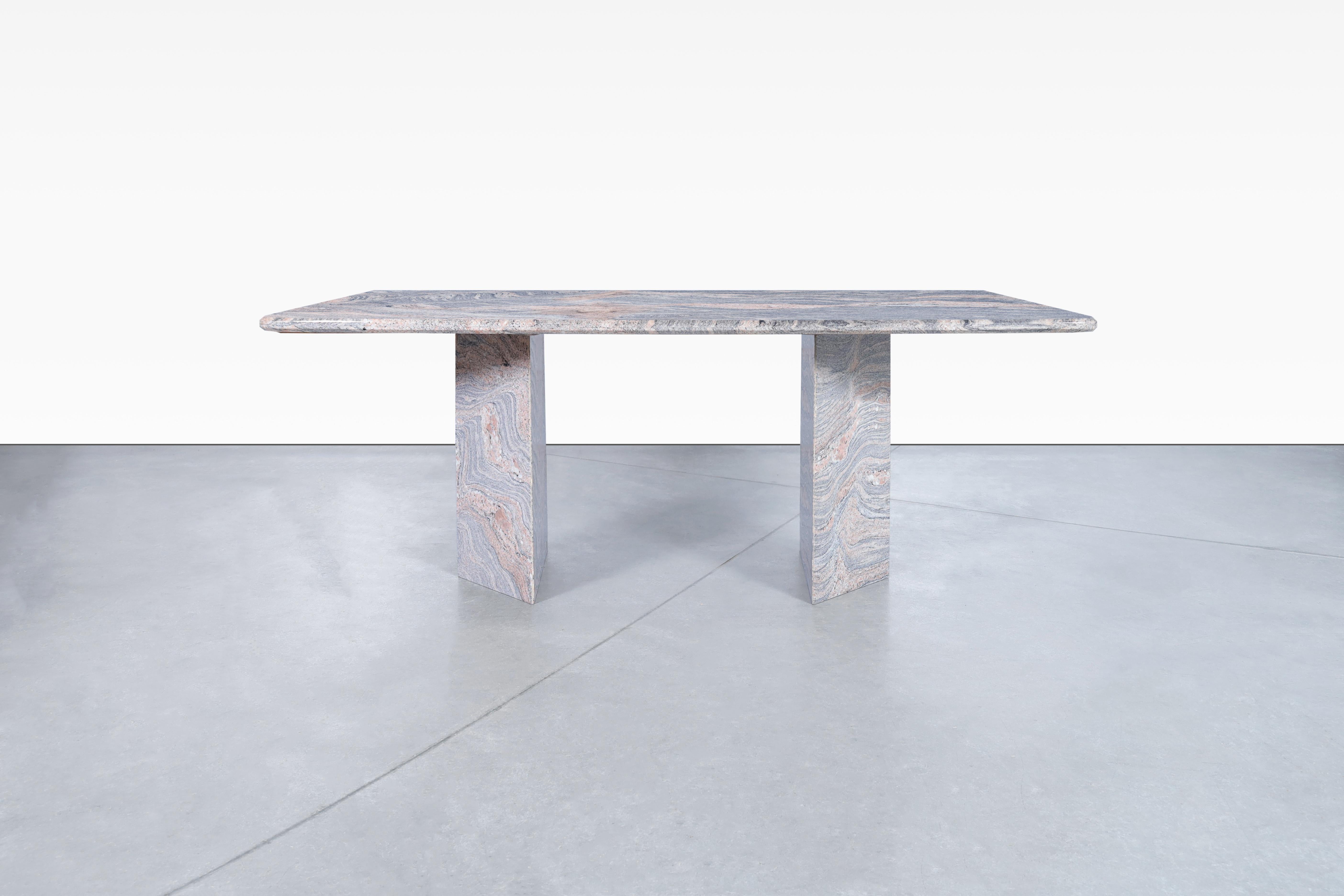Stunning vintage Italian granite dining table manufactured in Italy, circa 1980s. This table is built from granite stone, where the minerals that compose this stone shine through the entire table, giving it a fantastic contrast of colors and veins