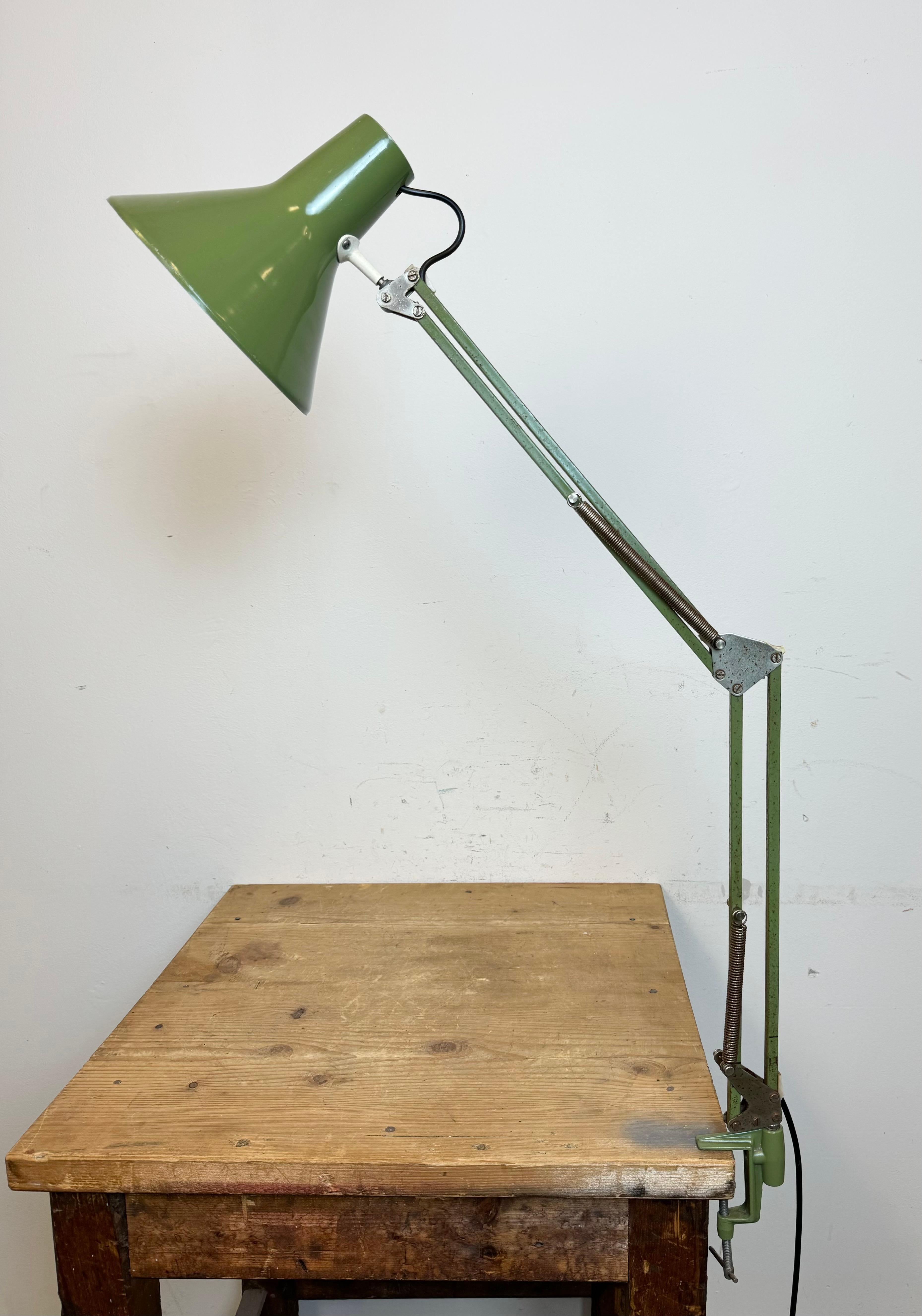 Vintage green adjustable table lamp made in Italy during the 1970. Adjustable in all desired positions. It features an aluminium shade and an iron arm with clamp base. The socket requires standard E 27/ E 26 light bulbs. The diameter of the shade is
