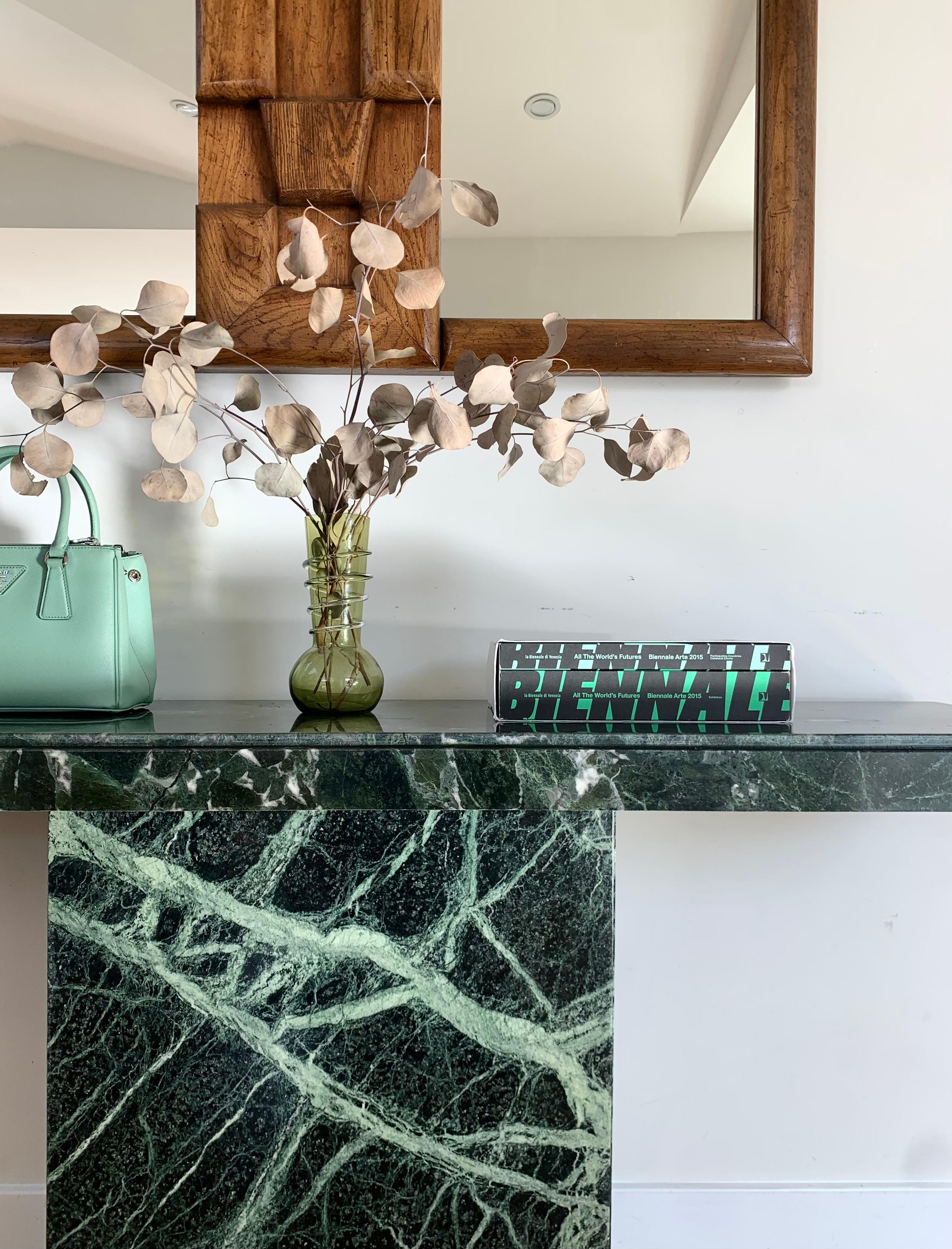 An extremely rare vintage Italian marble console table in shades of pine green with seafoam veining, 1970s. This piece features a pedestal base and sculpted geometric edge classic to the postmodern design of the period. This table will serve as a