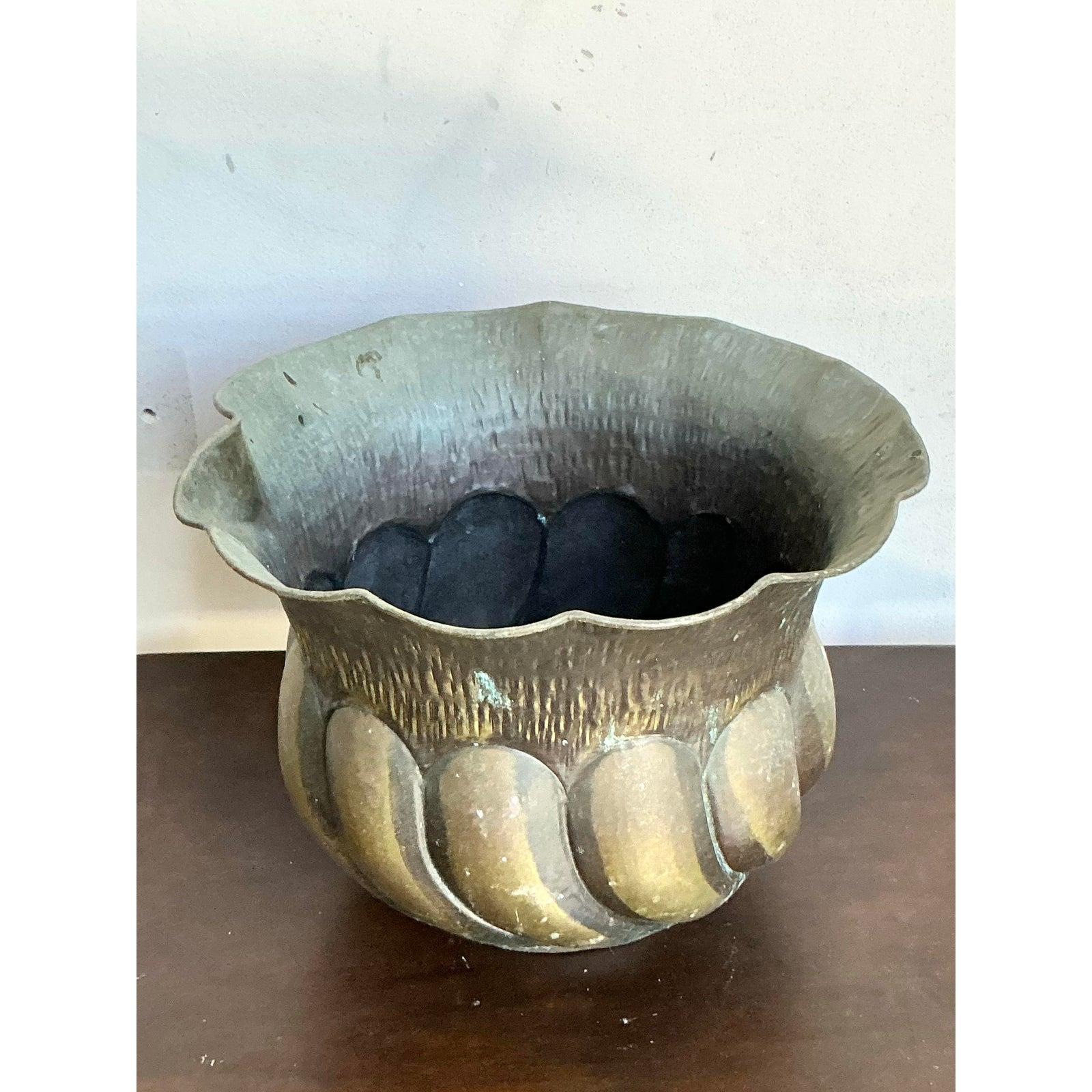 Introduce a touch of timeless European elegance to your home with this exquisite Vintage Italian Hammered Brass Planter. This magnificent decorative vessel boasts a rich history and exceptional craftsmanship, evident in its beautifully textured