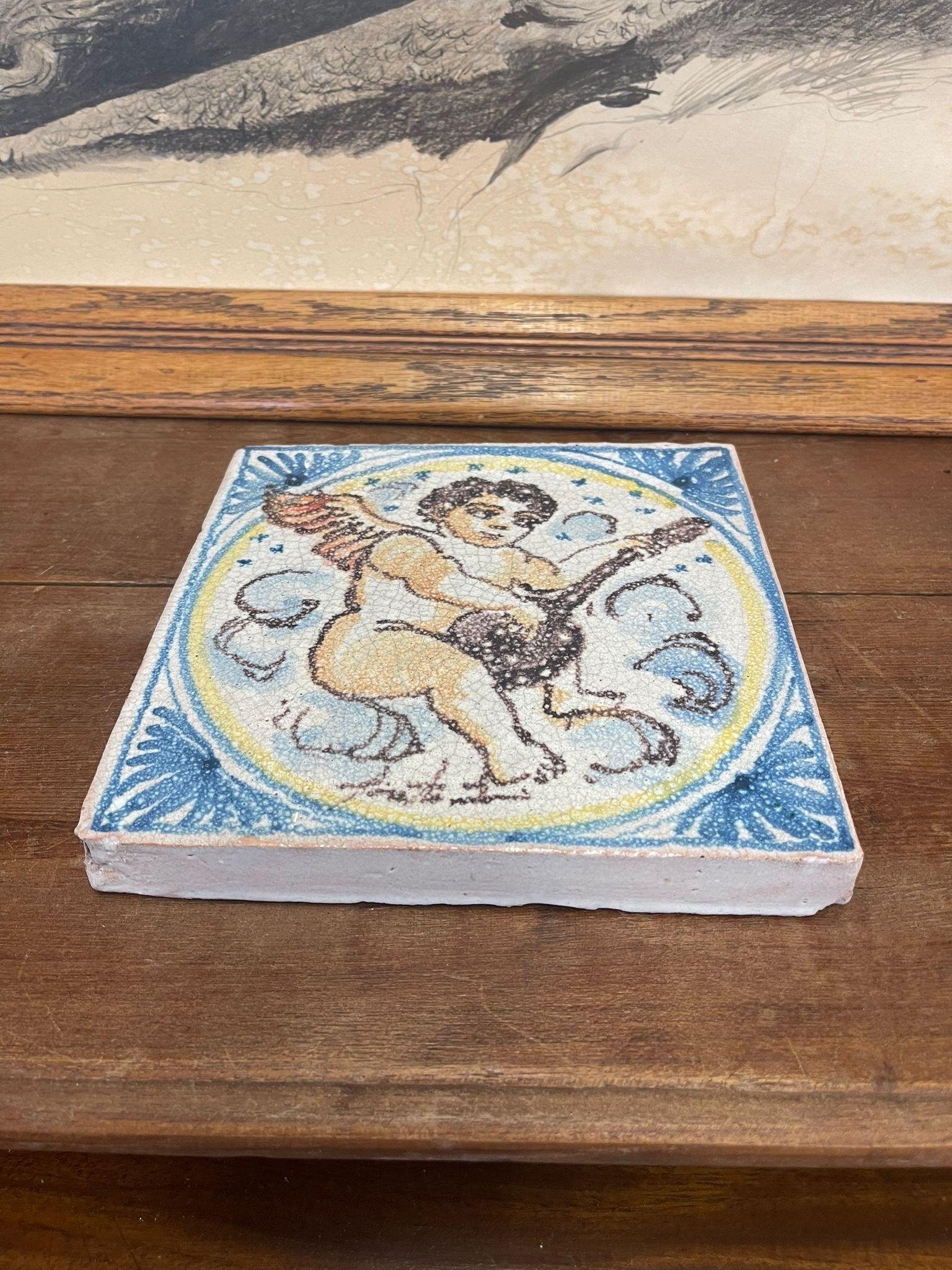 Makers mark on the bottom shows that this tile was made by Fratantoni Ceramiche, a tiling company based out of Italy. Beautiful Cherub motif adorns the Ceramic tile Blue and Yellow highlights. Vintage Condition Consistent with Age as
