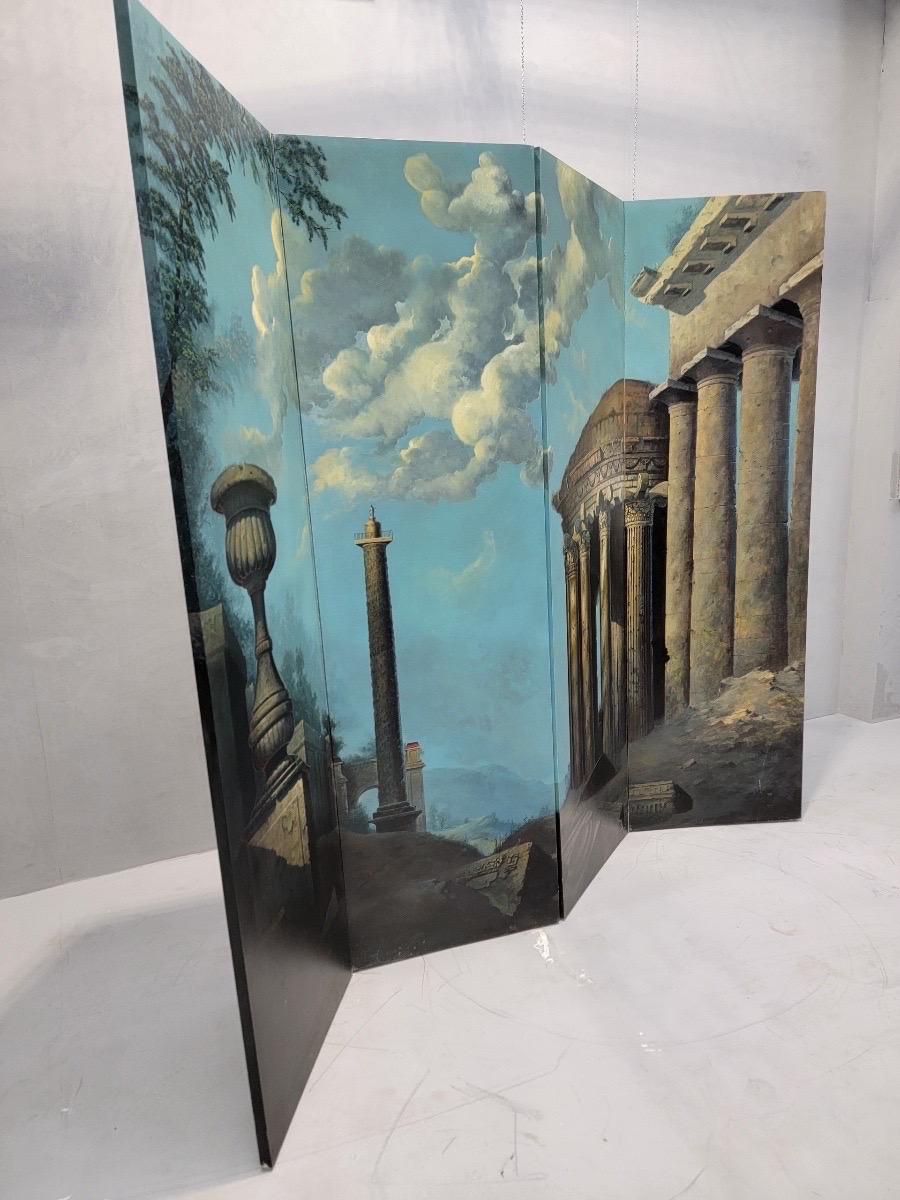 Vintage Italian Hand Painted Screen Styled After Maitland Smith

The ruins of Roman buildings overlook wooded hills. Expressive clouds float in the pale blue sky. This pensive scene is painted on a large wooden divider screen. Bring a classical