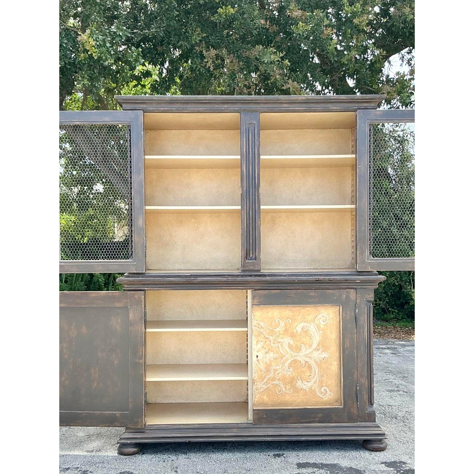 Imbue your home with the rustic elegance of Tuscany with this exceptional Grand Vintage Italian Hand-Painted & Distressed Display Cabinet. A masterpiece of artisanal craftsmanship, this commanding piece features a robust solid wood construction