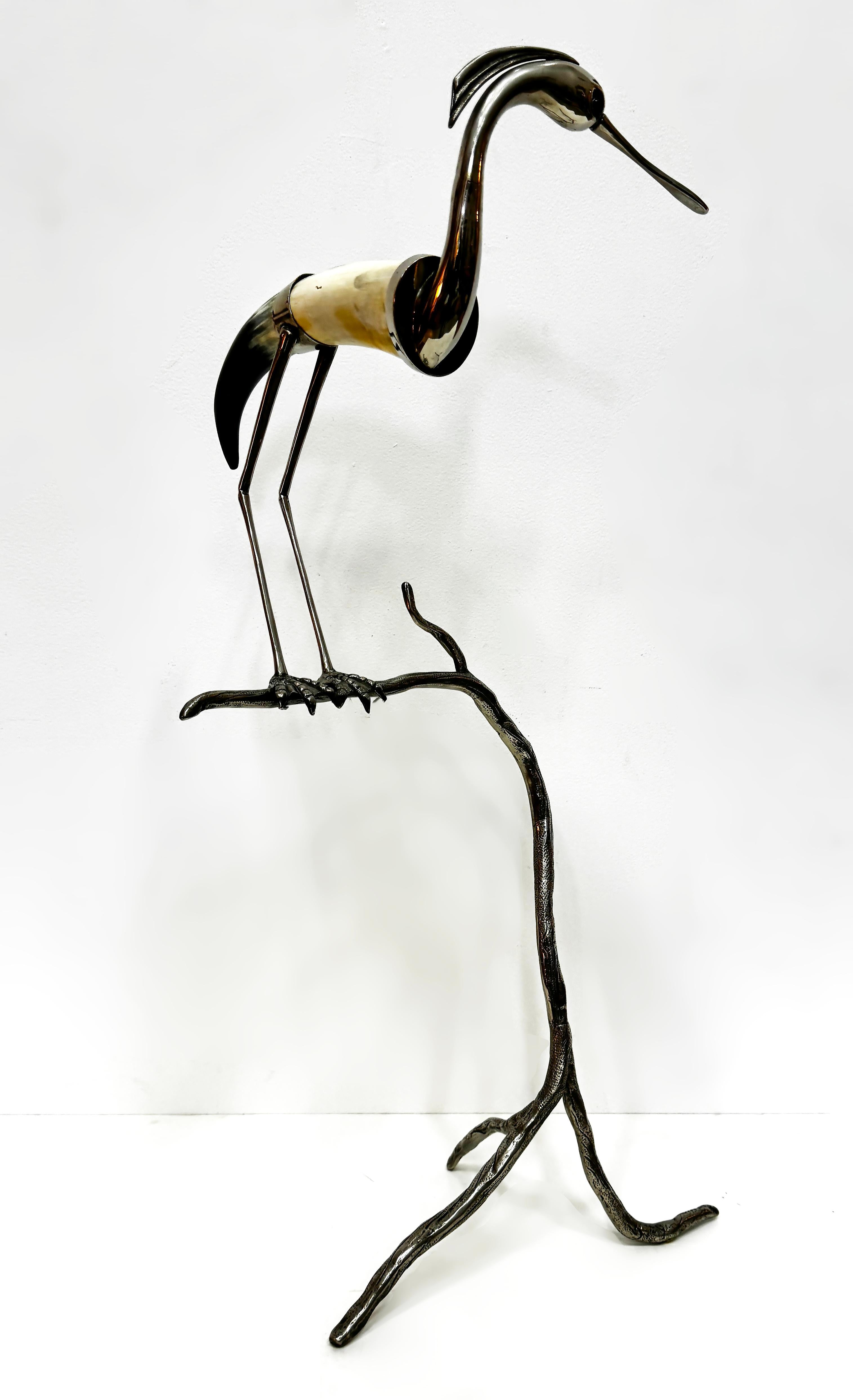 Vintage Italian Hauy Pouigo Crane or Heron Sculpture in Horn and Silver 

Offered for sale is a circa 1970s polished steer/cow horn and silver sculpture of a heron or crane perched on a tree branch. We do not know the content or the silver. The