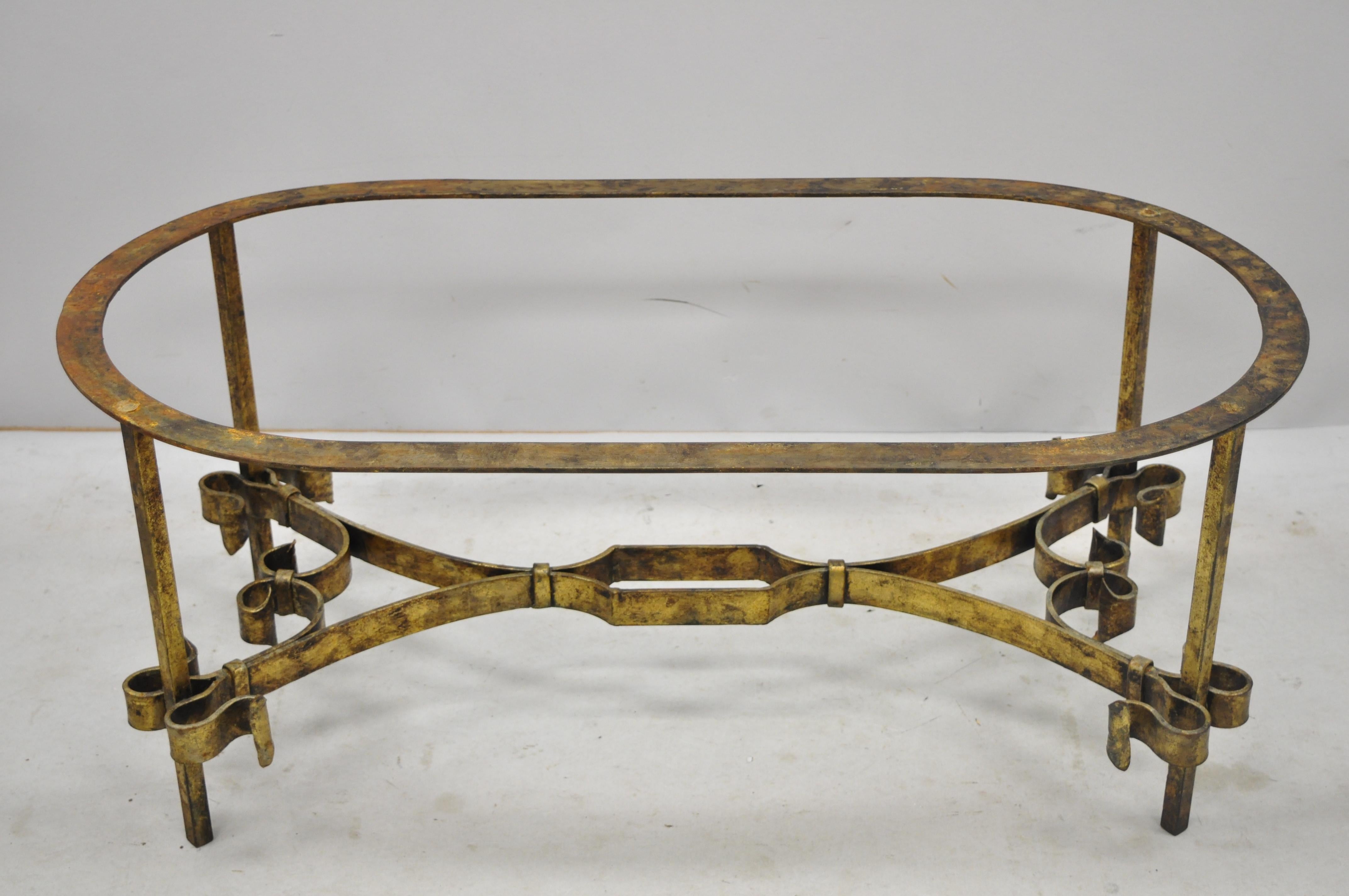 Vintage Italian Hollywood Regency gold gilt iron oval coffee table base. Listing includes heavy iron construction, fancy scrollwork frame, oval top, stretcher base, distressed finish, great style and form. No glass, circa mid-20th century.