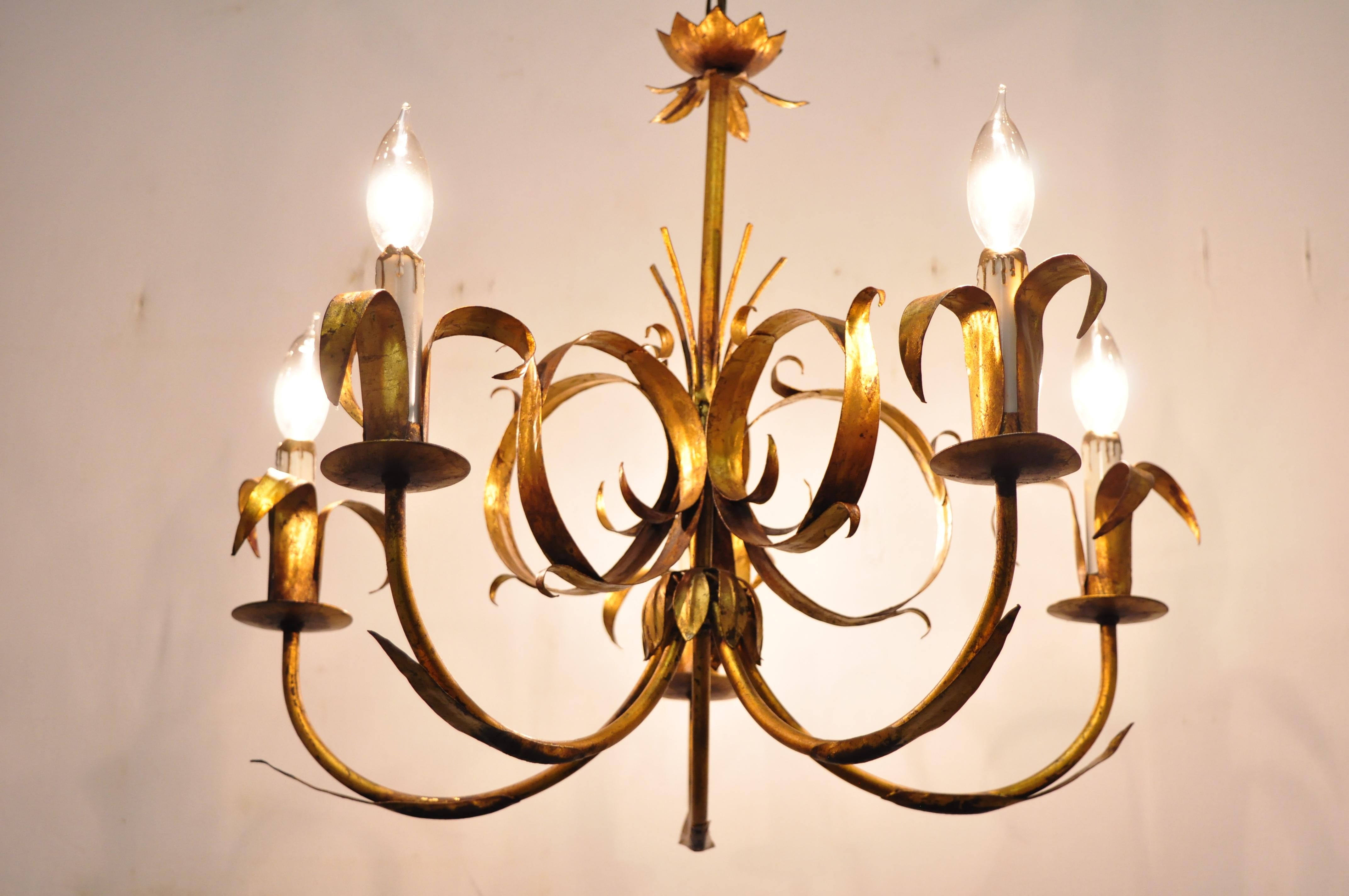 Vintage Italian Hollywood Regency gold gilt tole metal chandelier by Ferrocolor, Spain.
Details: 5 lights, leafy scrollwork frame, original label, great style and form
Age: Mid-20th century
Measurements: 18