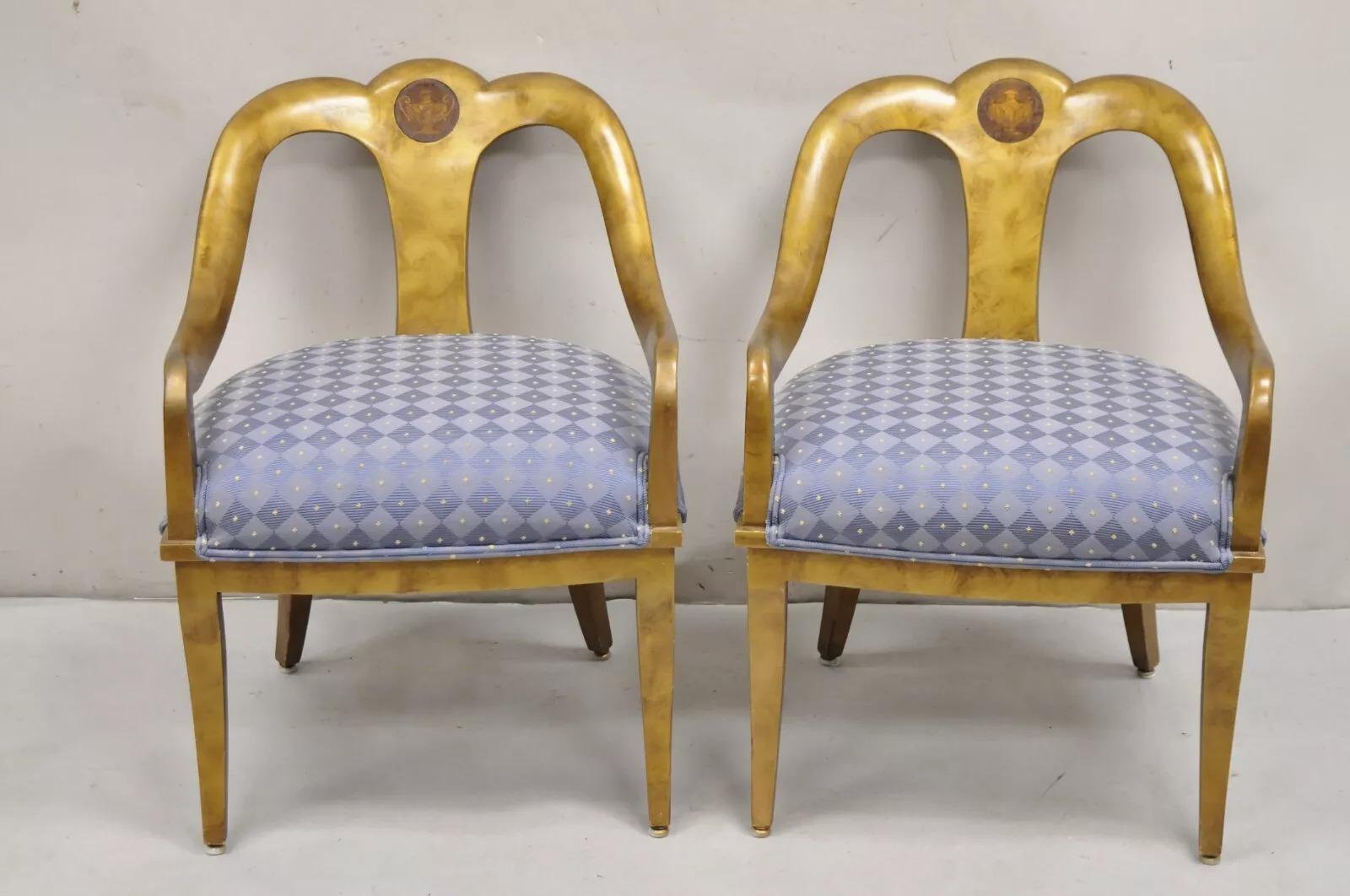 Vintage Italian Hollywood Regency Gold Gilt Wood Saber Leg Lounge Chairs with Urn Inlay and Distressed Gold Leaf Finish - Pair. Circa Mid 20th Century. Measurements: 31