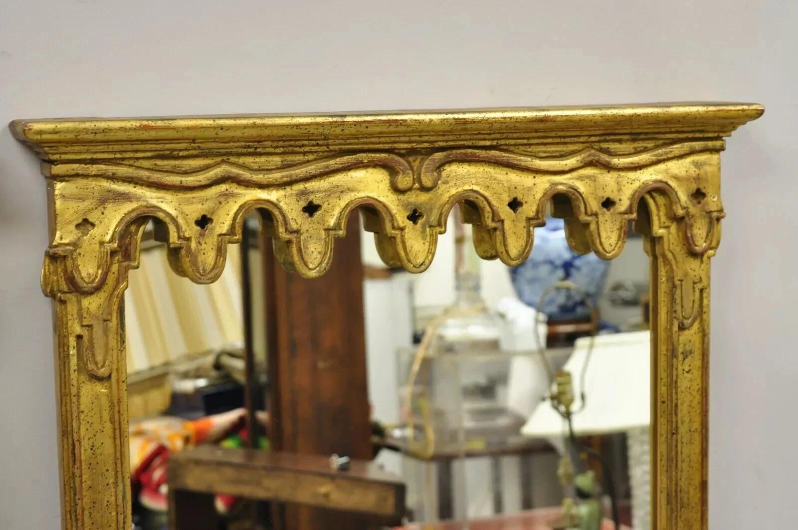 Vintage Italian Hollywood Regency Gold Giltwood Narrow Wall Mirrors - a Pair. Item features carved giltwood frames with drape pediment, distressed finish, original label, quality Italian craftsmanship. Circa Mid 20th Century. Measurements: 57.25