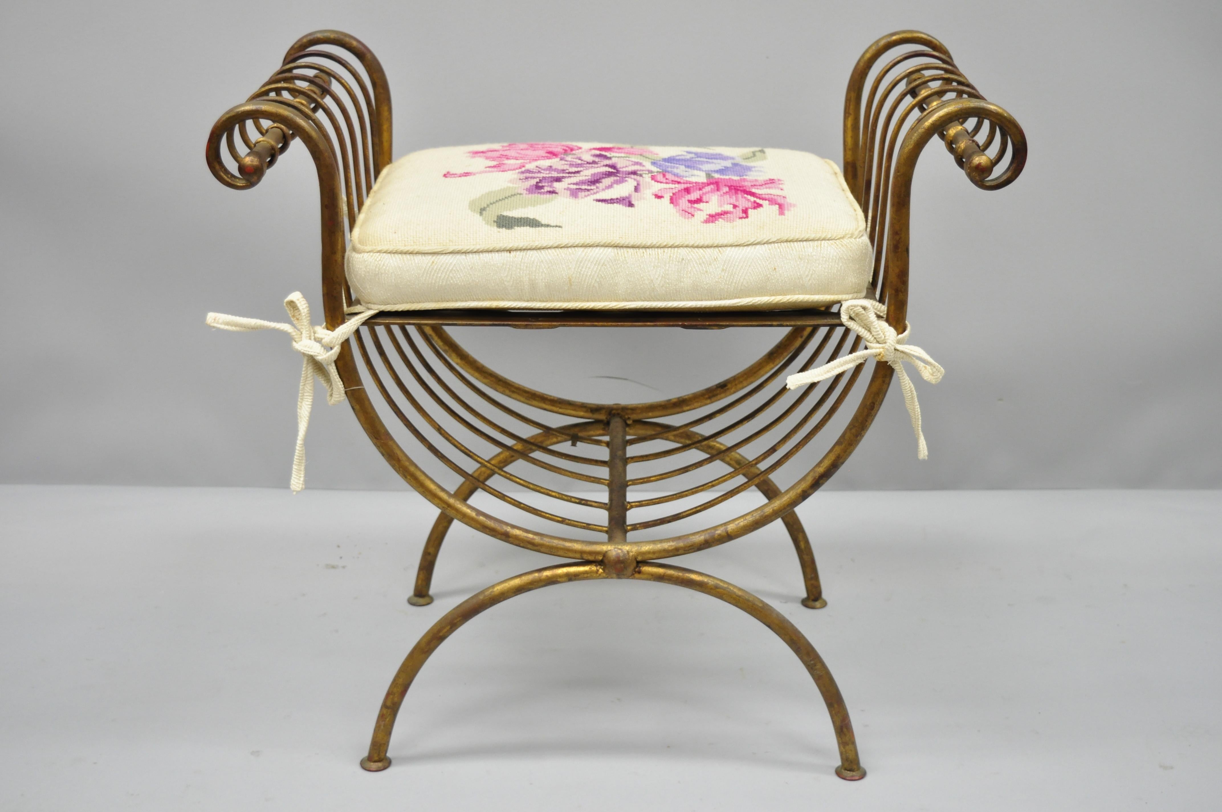 Vintage Italian Hollywood Regency iron gold gilt curule vanity bench seat chair. Item features gold gilt, curule frame, loose cushion, iron construction, distressed finish, and great style and form. Mid-20th century. Measurements: 24
