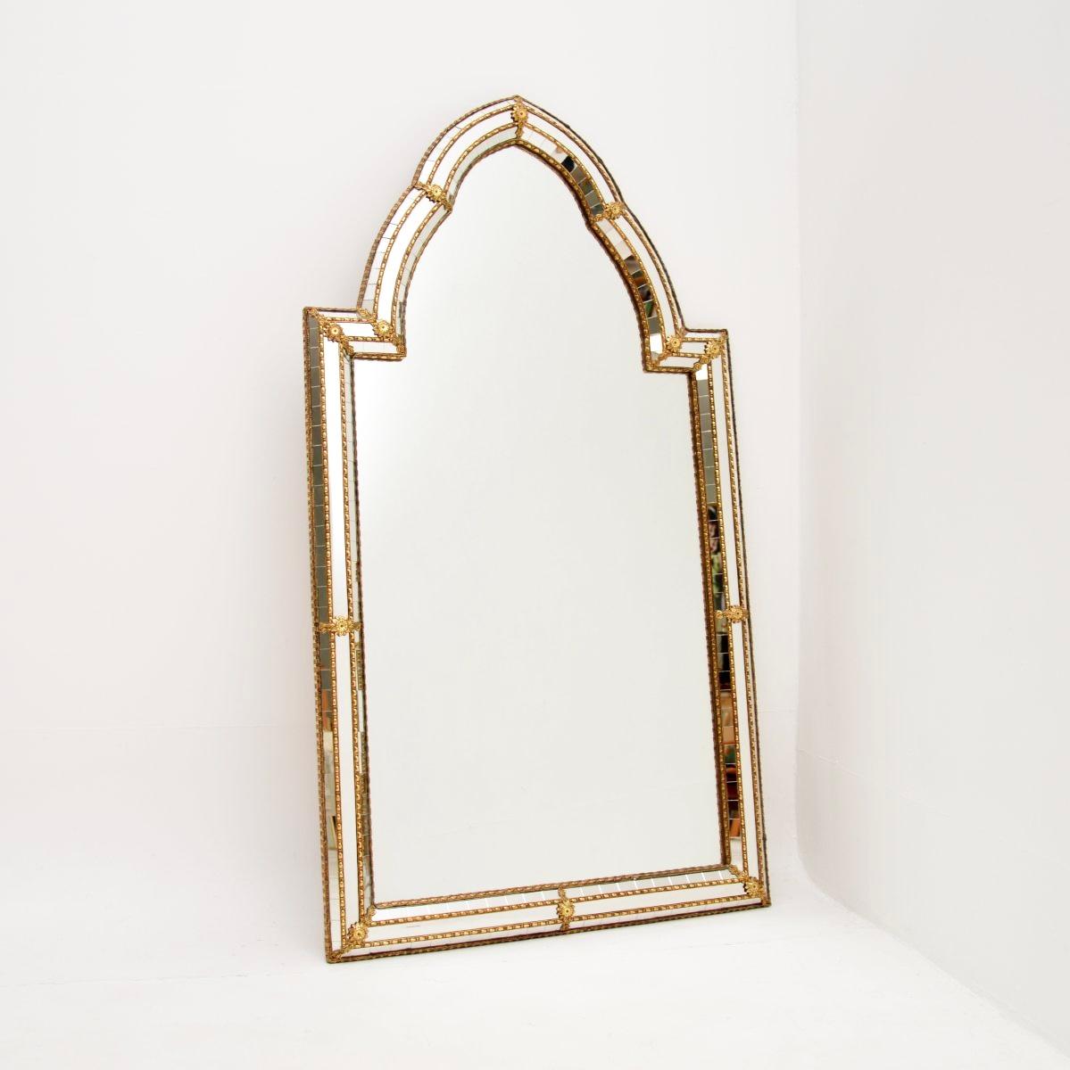 An extremely beautiful and stylish vintage Italian Hollywood Regency style mirror. This was made in Italy, it dates from around the 1970’s.

It is a large and impressive size, with a gorgeous design. This has a high arched top, intricate brass