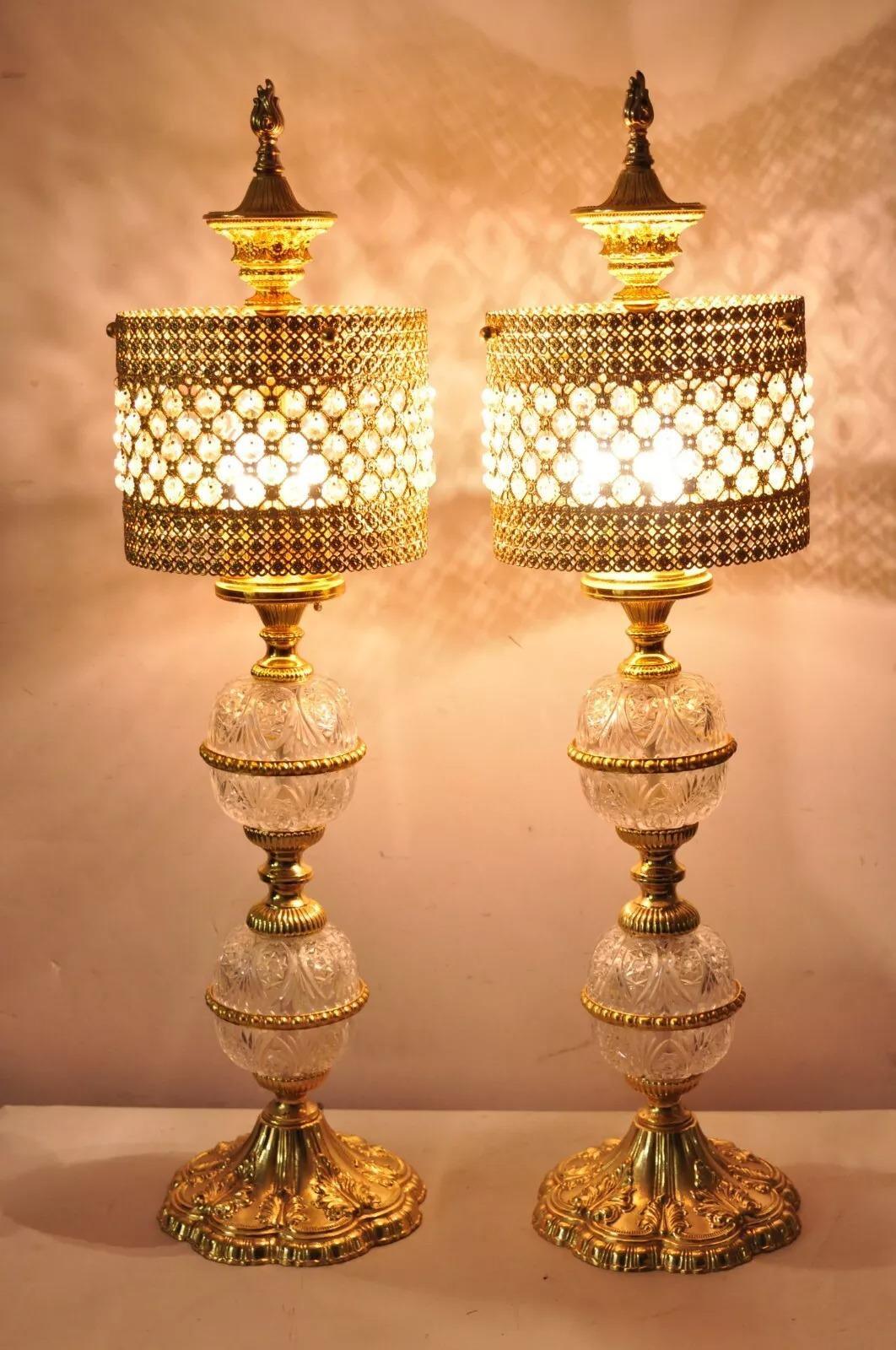 Vintage Italian Hollywoood Regency Gold Glass & Crystal Lantern Table Lamps - a Pair. Item features gold filigree shades, crystal prisms, three lights each, cut glass crystal ball columns, ornate pedestal base, great style and form. Circa Late 20th